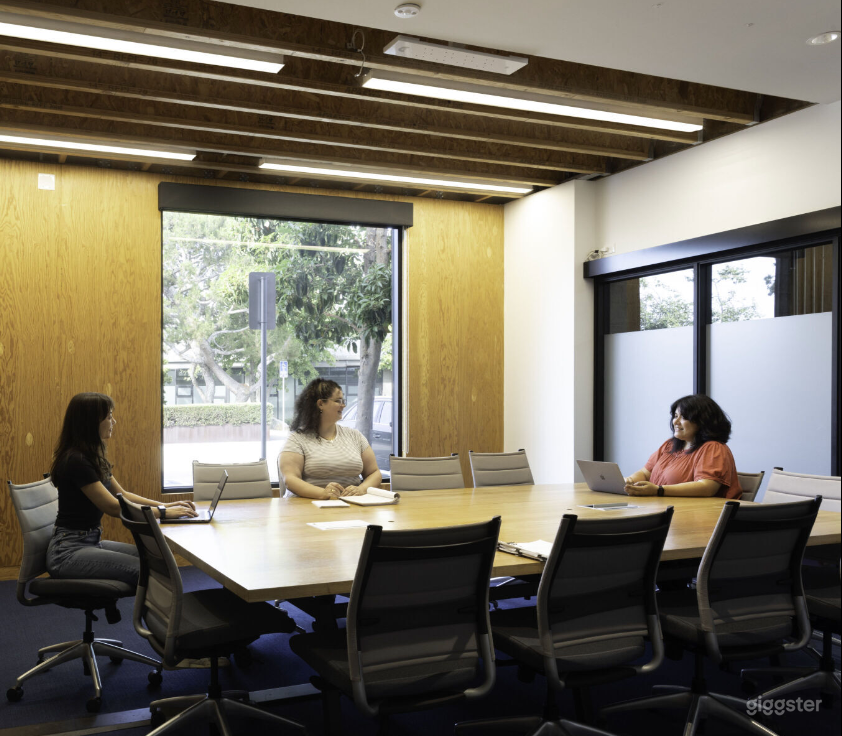 Large Conference Room with large tv, exterior and interior windows and a creative vibe