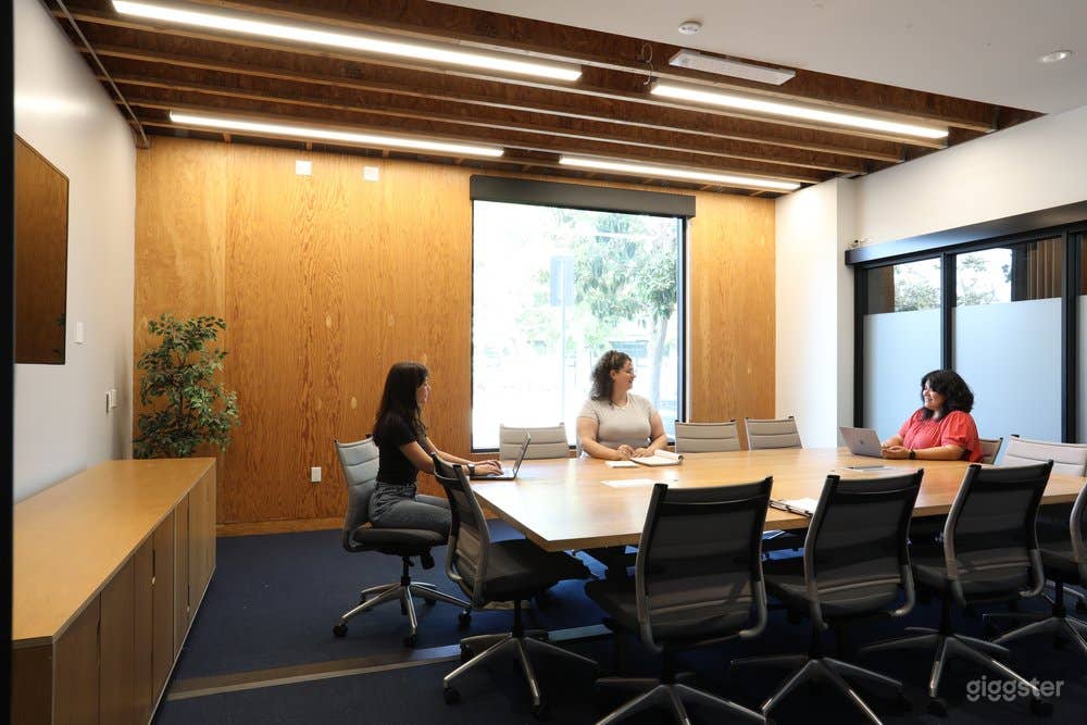 Large Conference Room with large tv, exterior and interior windows and a creative vibe