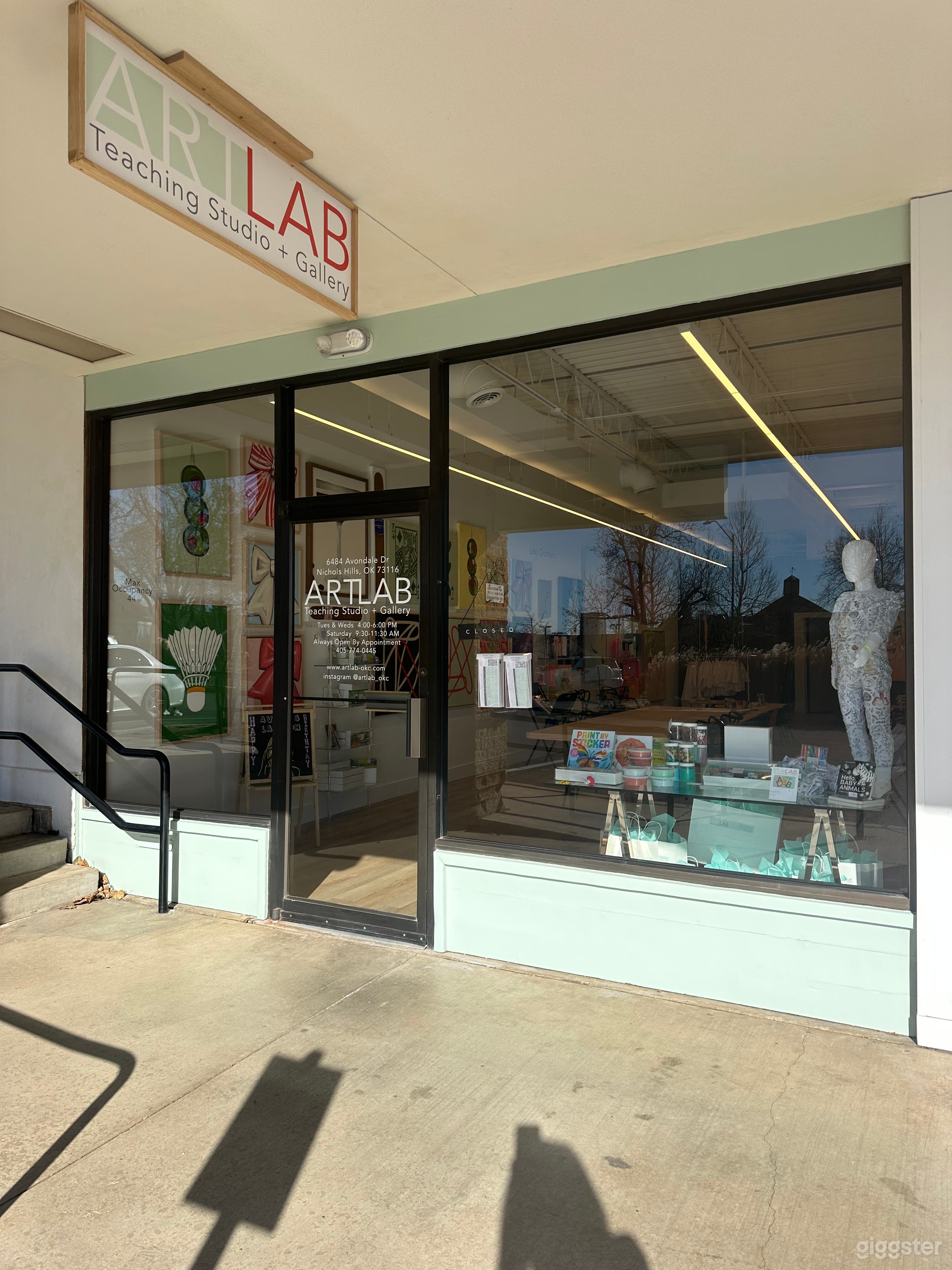 Store front. Approx 16’ wide x 11’ tall. Paint is mint green. Window displays can be removed. Features a 10’ walkway and curbside parking. 