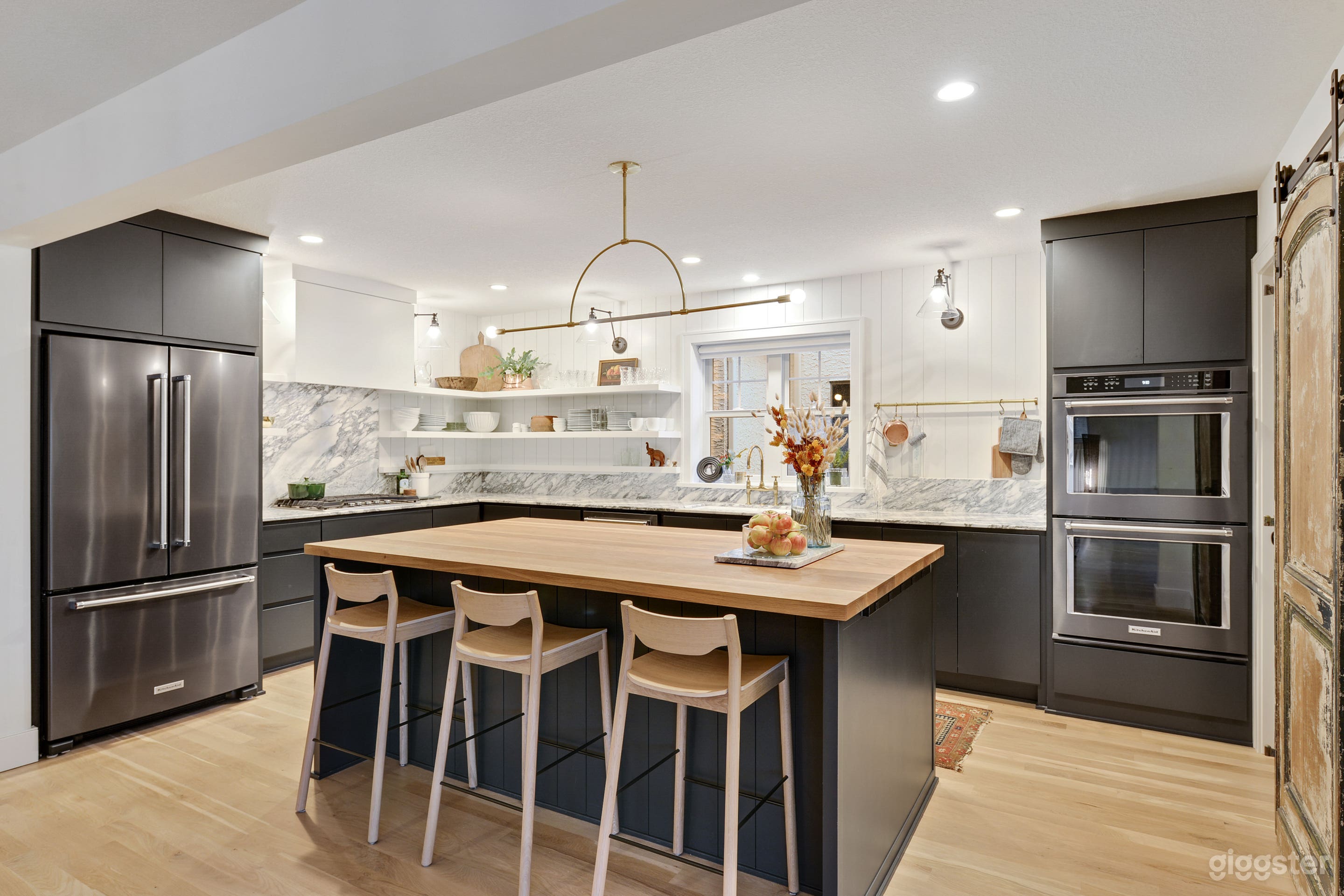 Modern, bright kitchen with live finishes; marble, unlacquered brass, butcher block. 