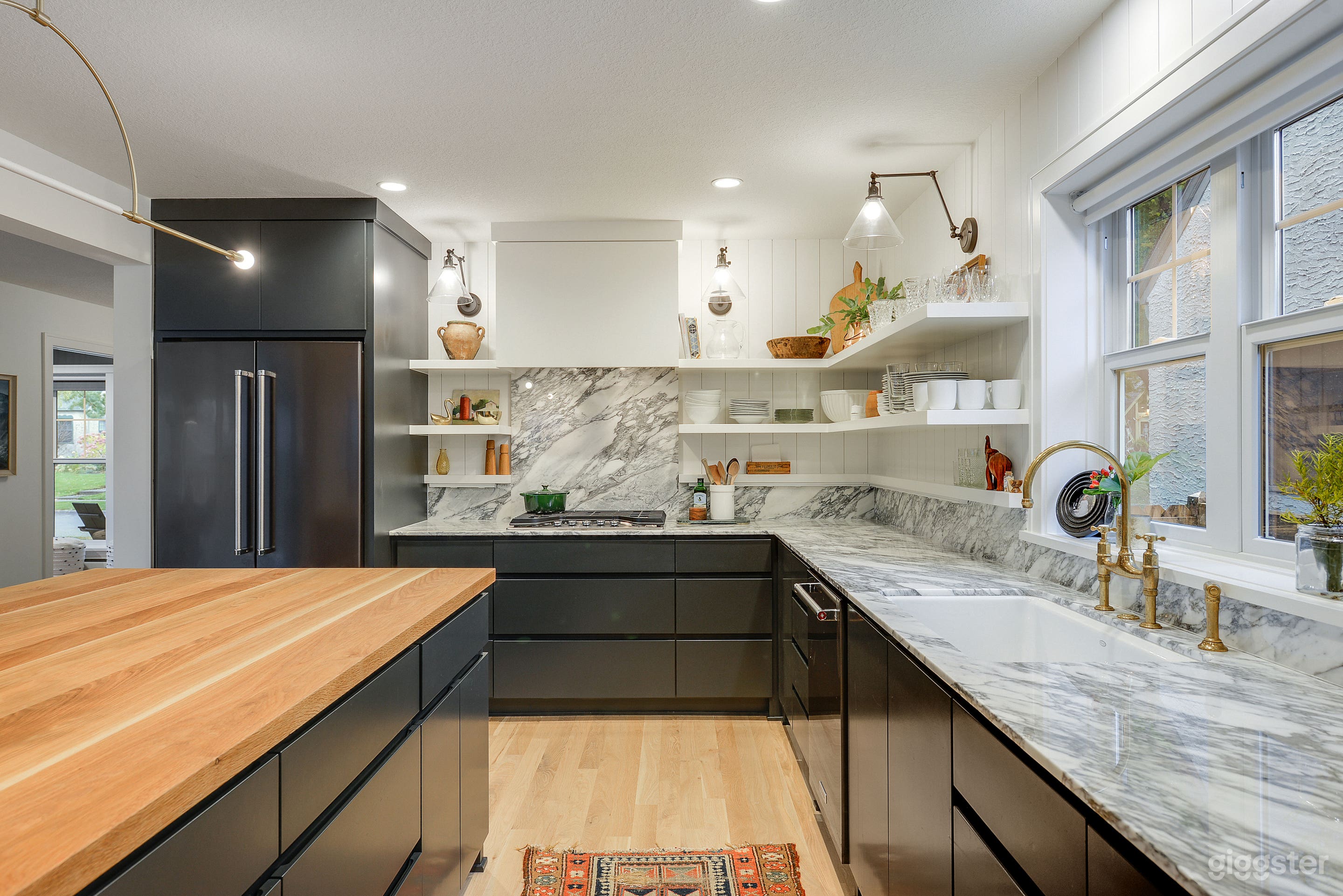 Modern kitchen; butcher block, white oak island. Marble counters. White or clear articulating sconces. Aged brass Devol faucet and sprayer. Cast iron sink. Gas cooktop.