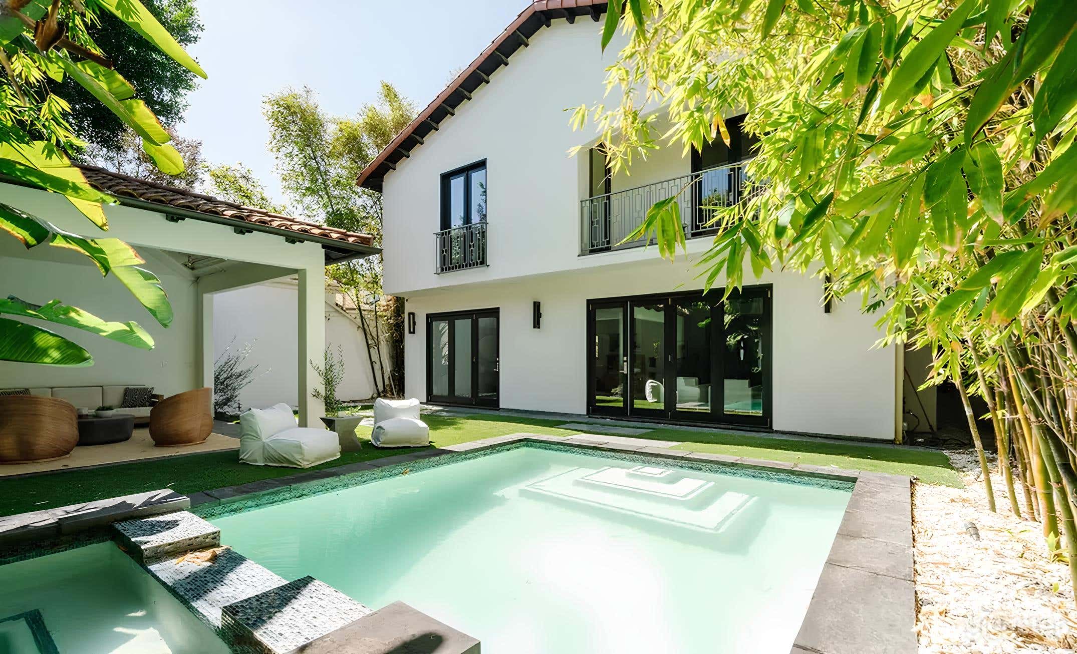 Spanish-Inspired Modern Backyard with Pool and Lounge Photo 3