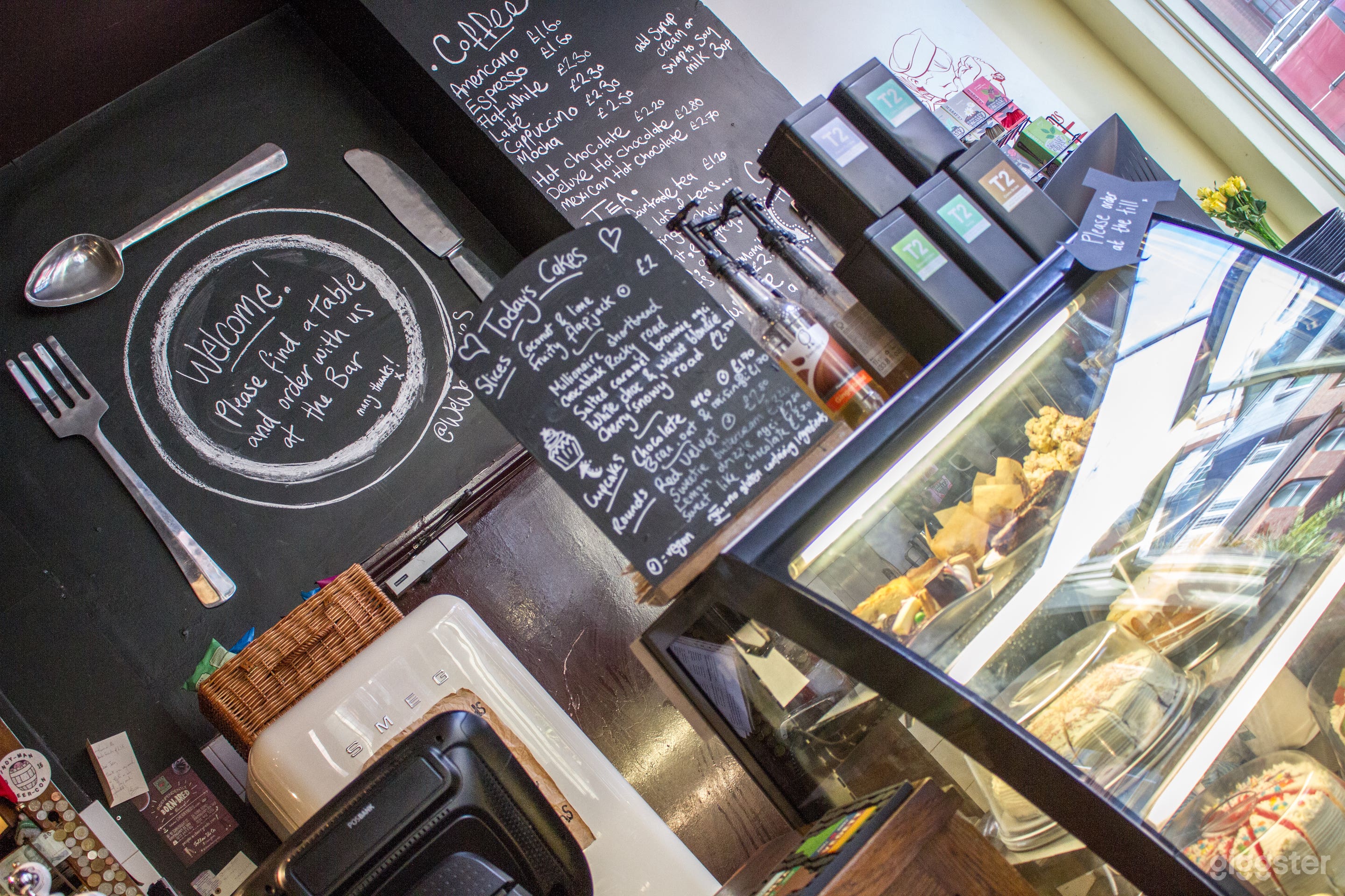 Downstairs bar, coffee area with cake fridge and blackboards