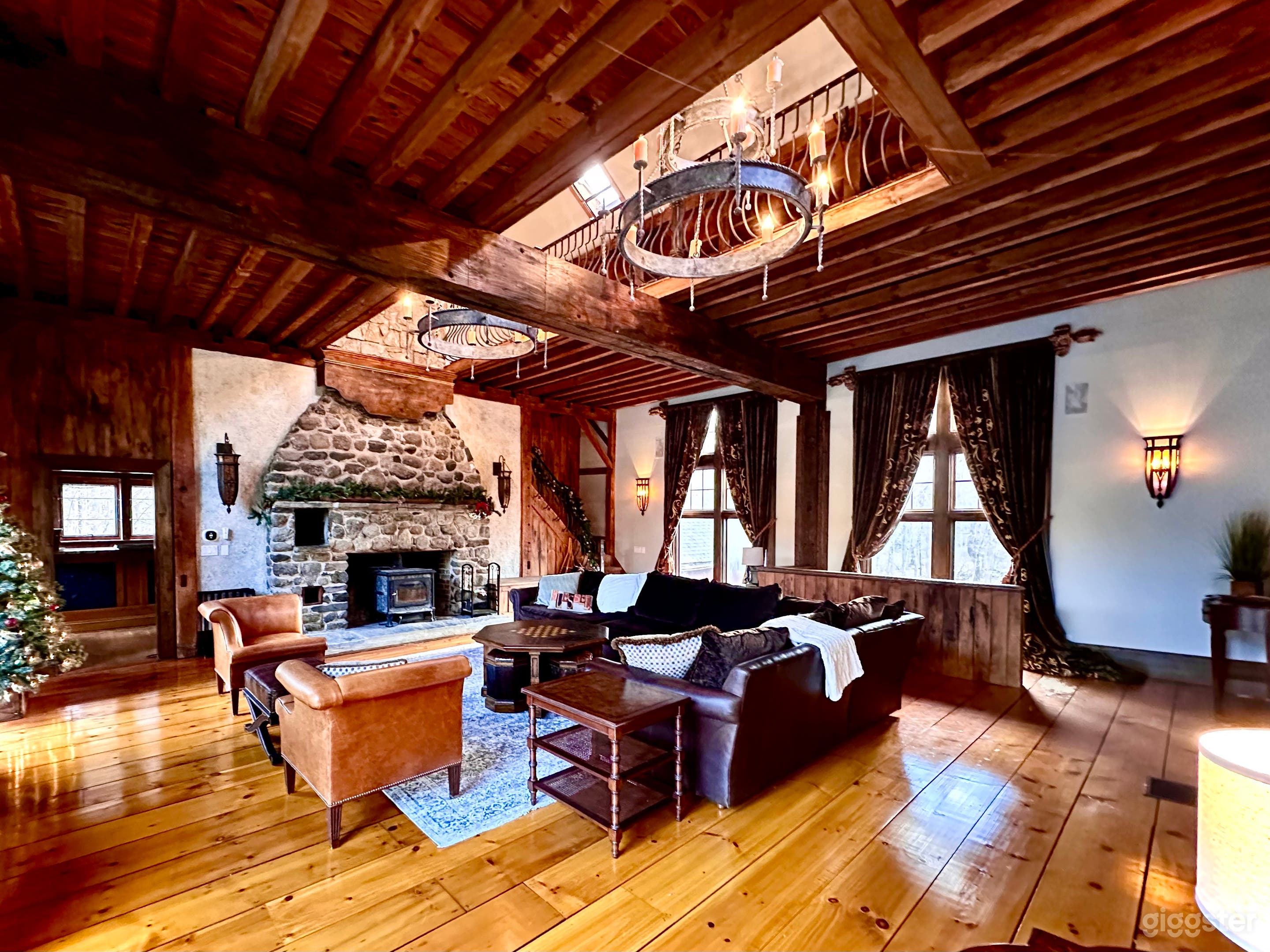 Great Room, antique velvet curtains, leather lined stair rail, post and beam 2 story ceiling. Restored historical Barn with 12" original wood planks. 