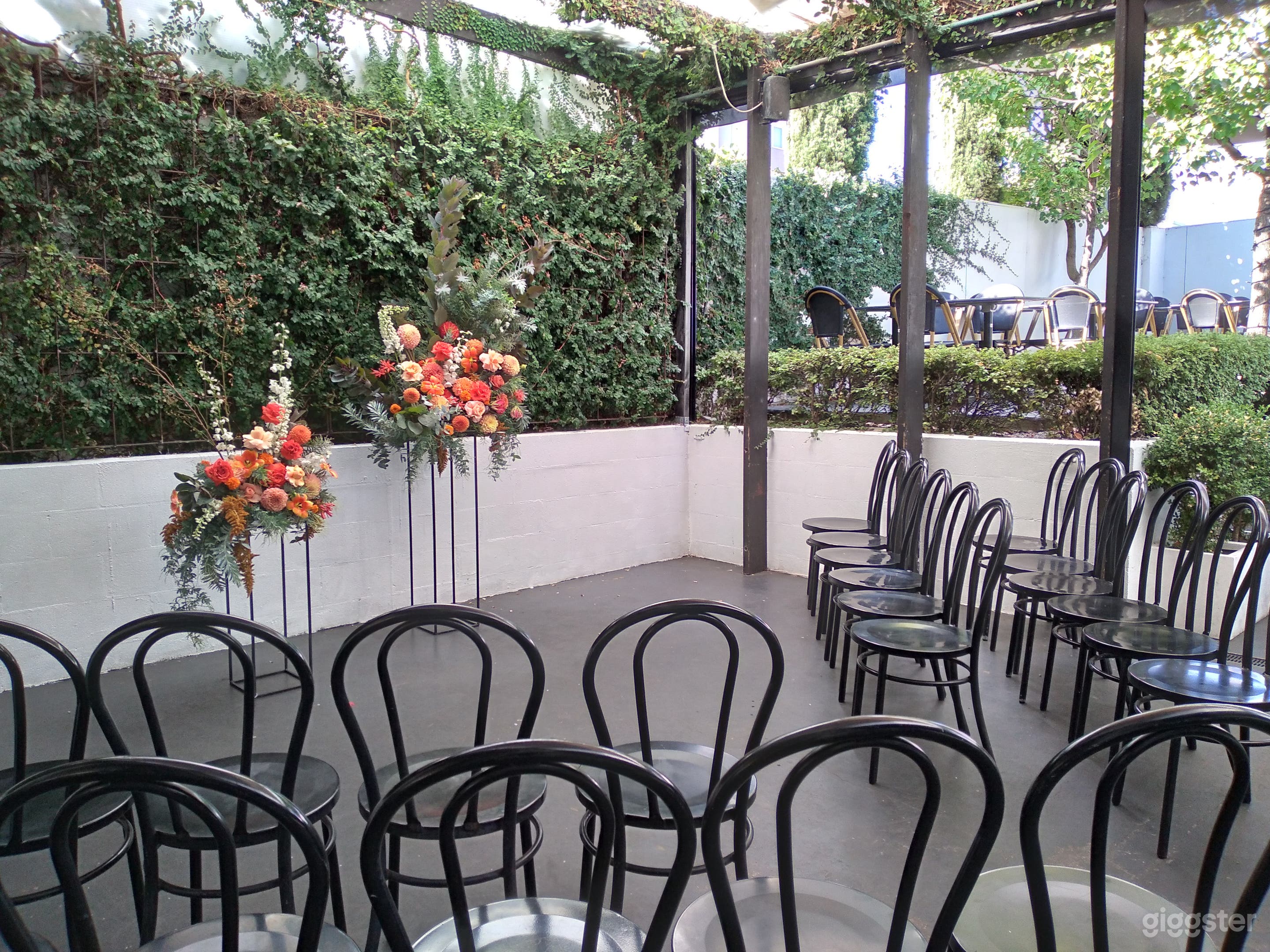 Ceremony set up in lower courtyard with green wall backdrop