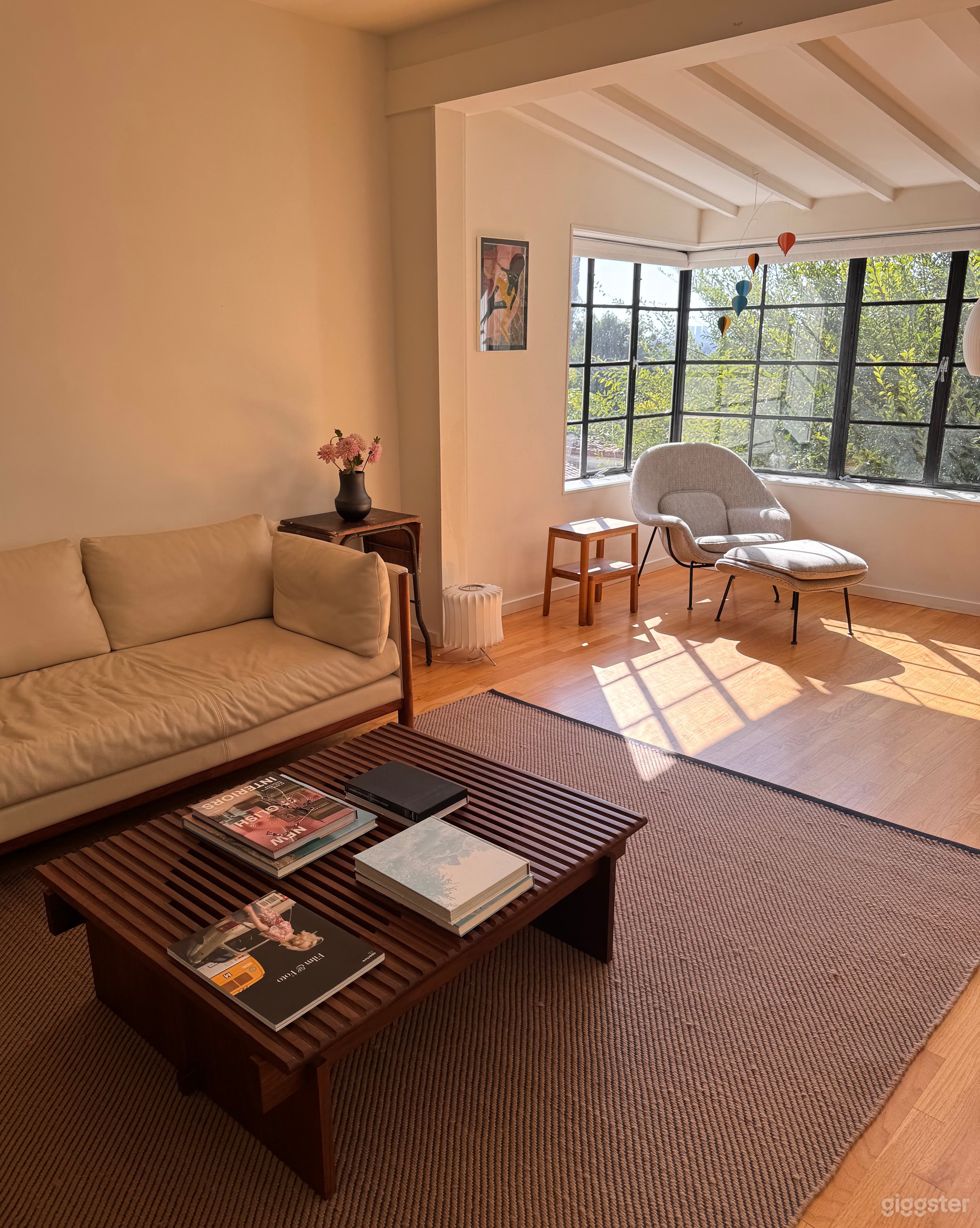 Warm, sun-filled living room with vaulted ceilings, Design Within Reach furnishings, and city views — perfect for film and lifestyle photography in Silver Lake.