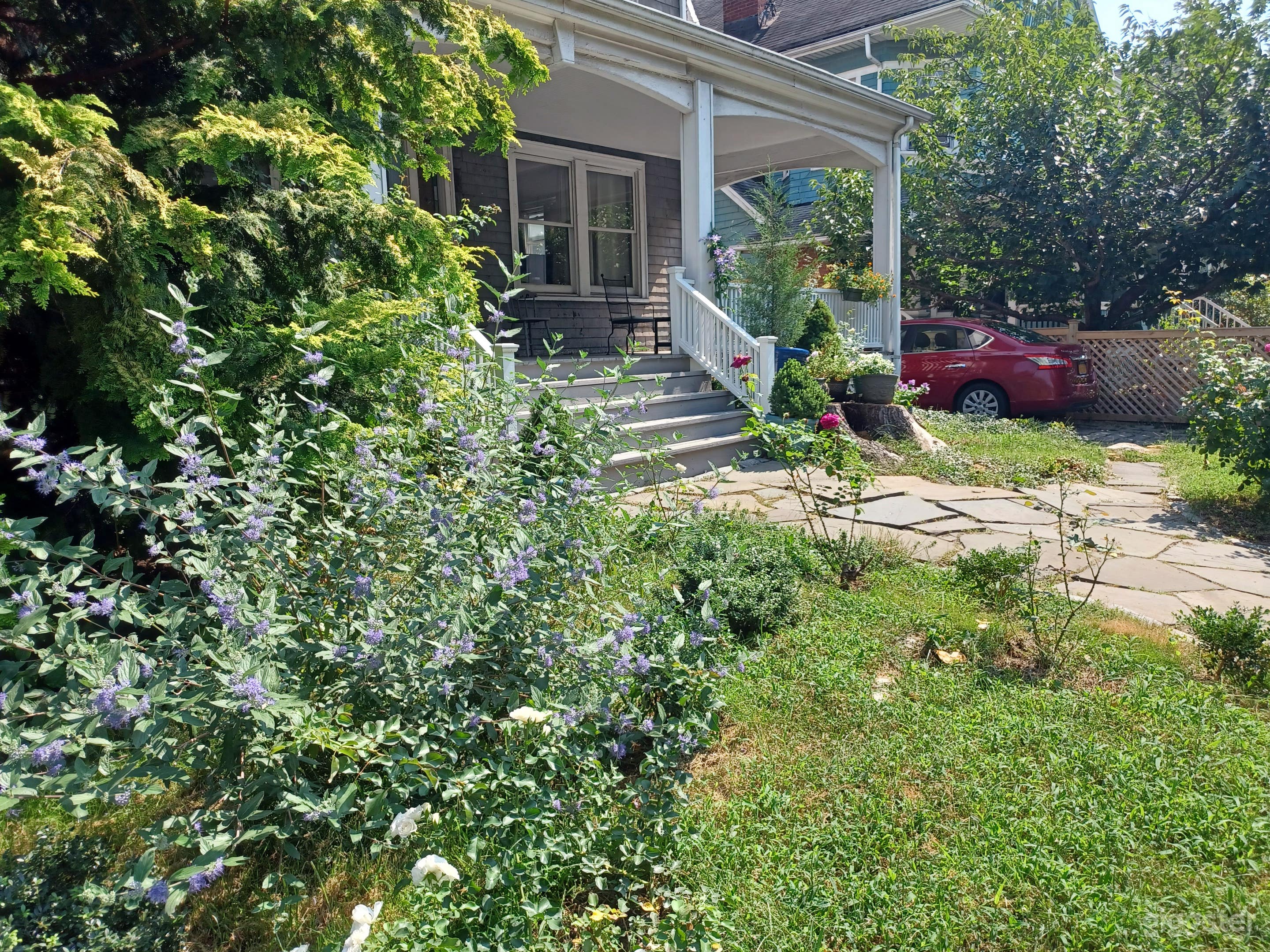 Country-style Victorian house with front porch and driveway