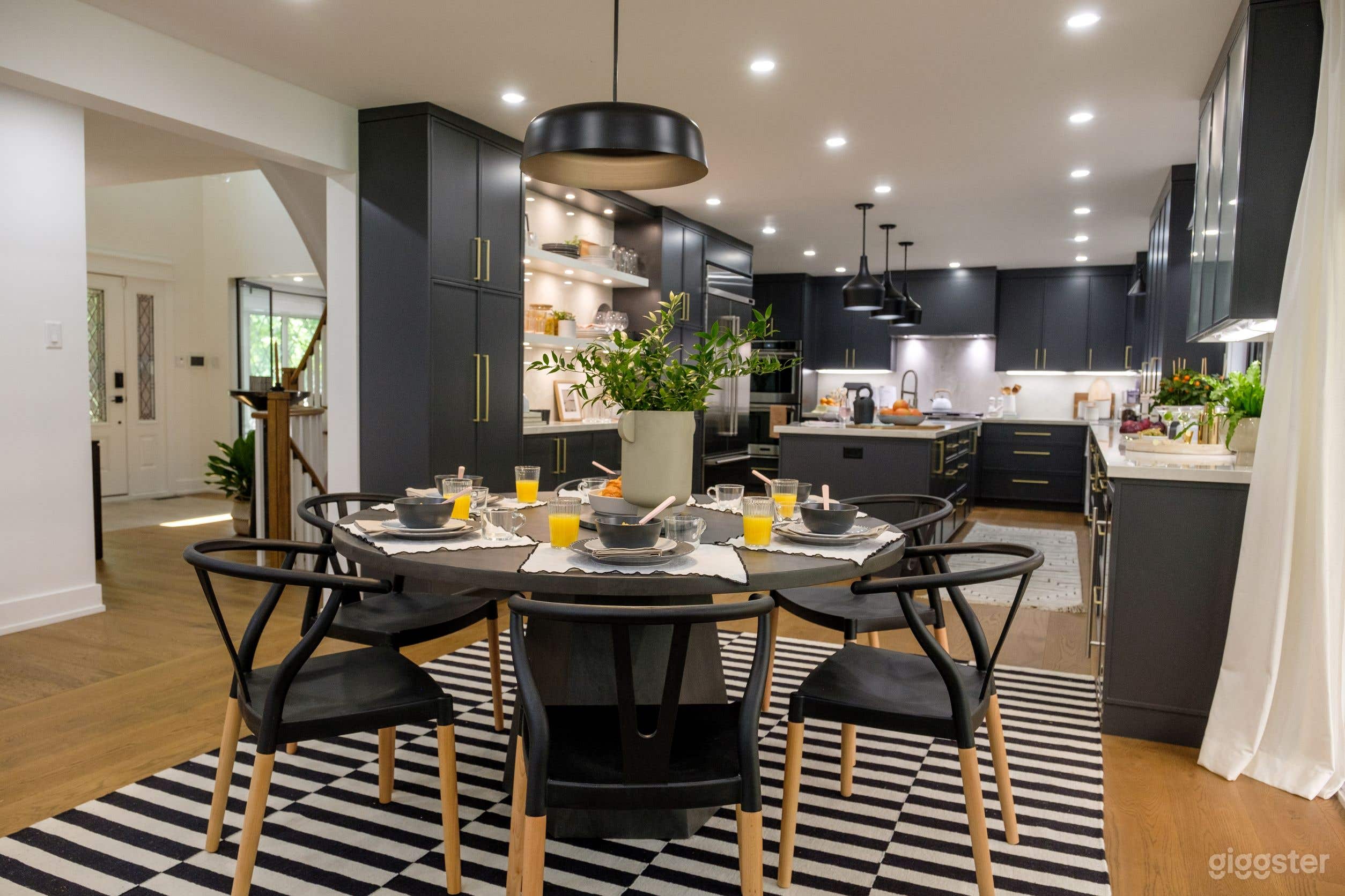 Dramatic and modern layout, featuring a ton of cupboard space, deep blue hues, and a large island that doubles as a prep space and even more guest seating.