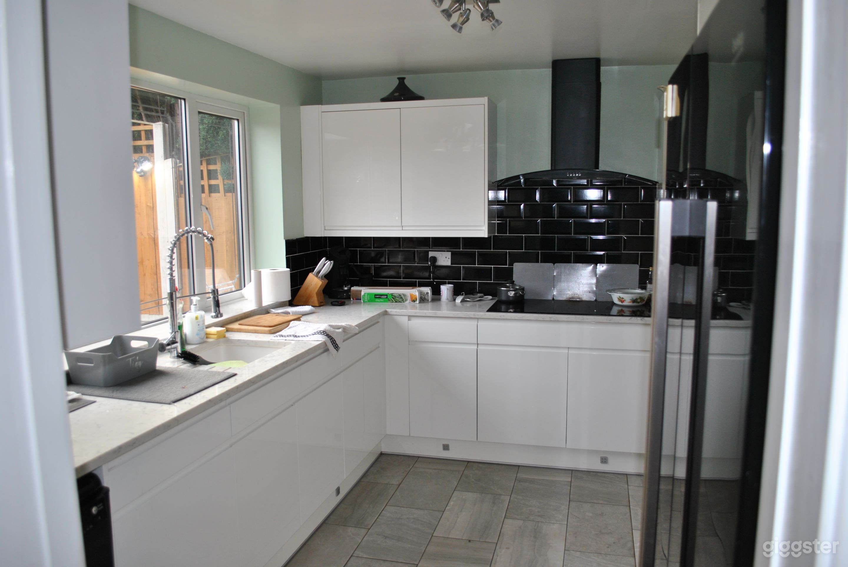 Far end just before conservatory to the right the "L"shaped kitchen.