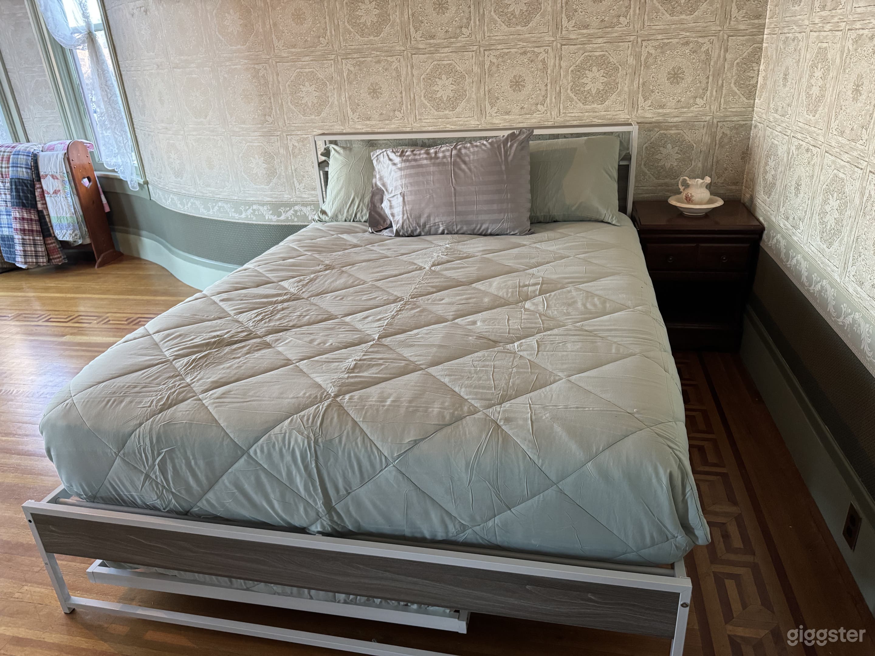 Downstairs bedroom: wood floors, wallpaper