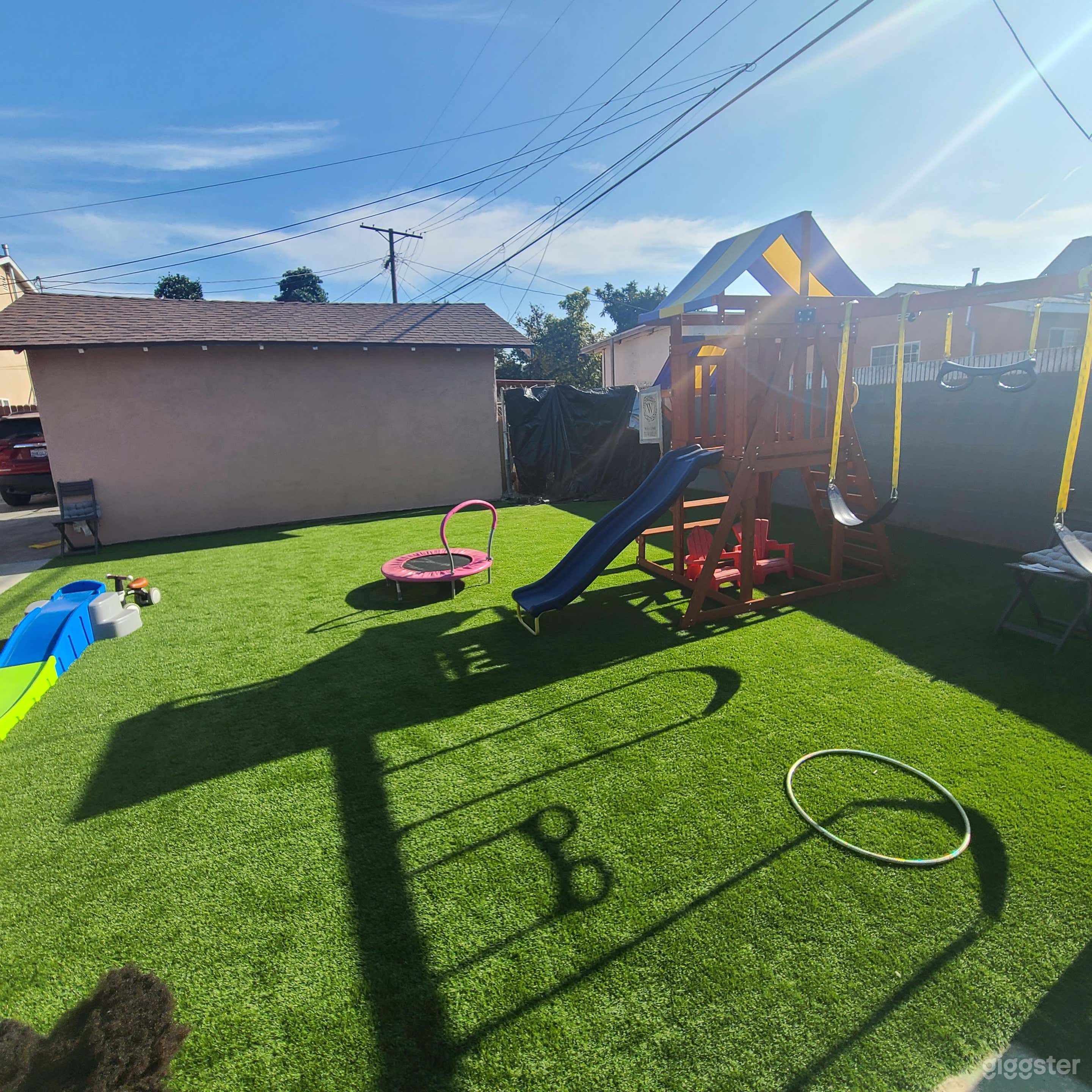 Vibrant Backyard with Playset and Patio Photo 2