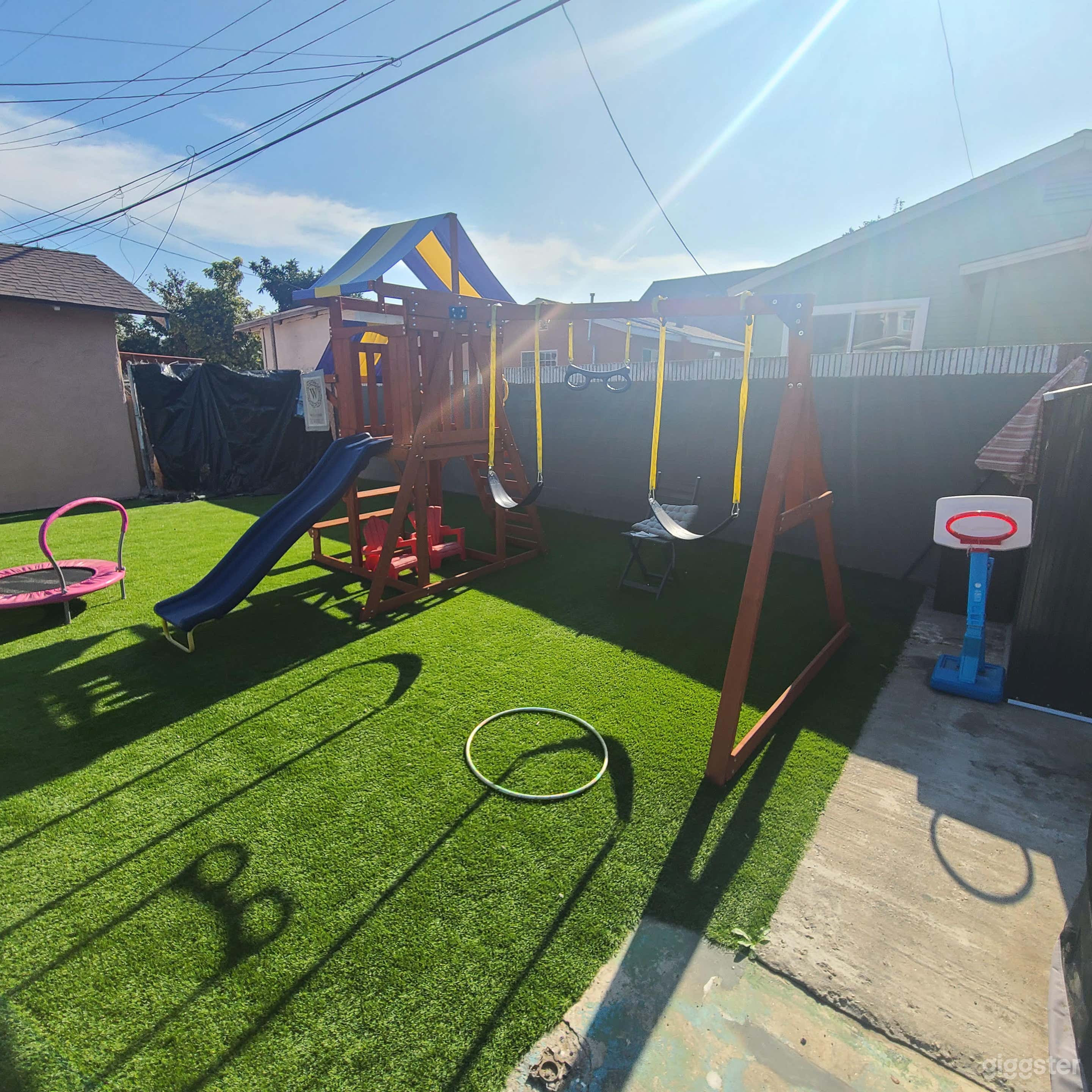 Vibrant Backyard with Playset and Patio Photo 1