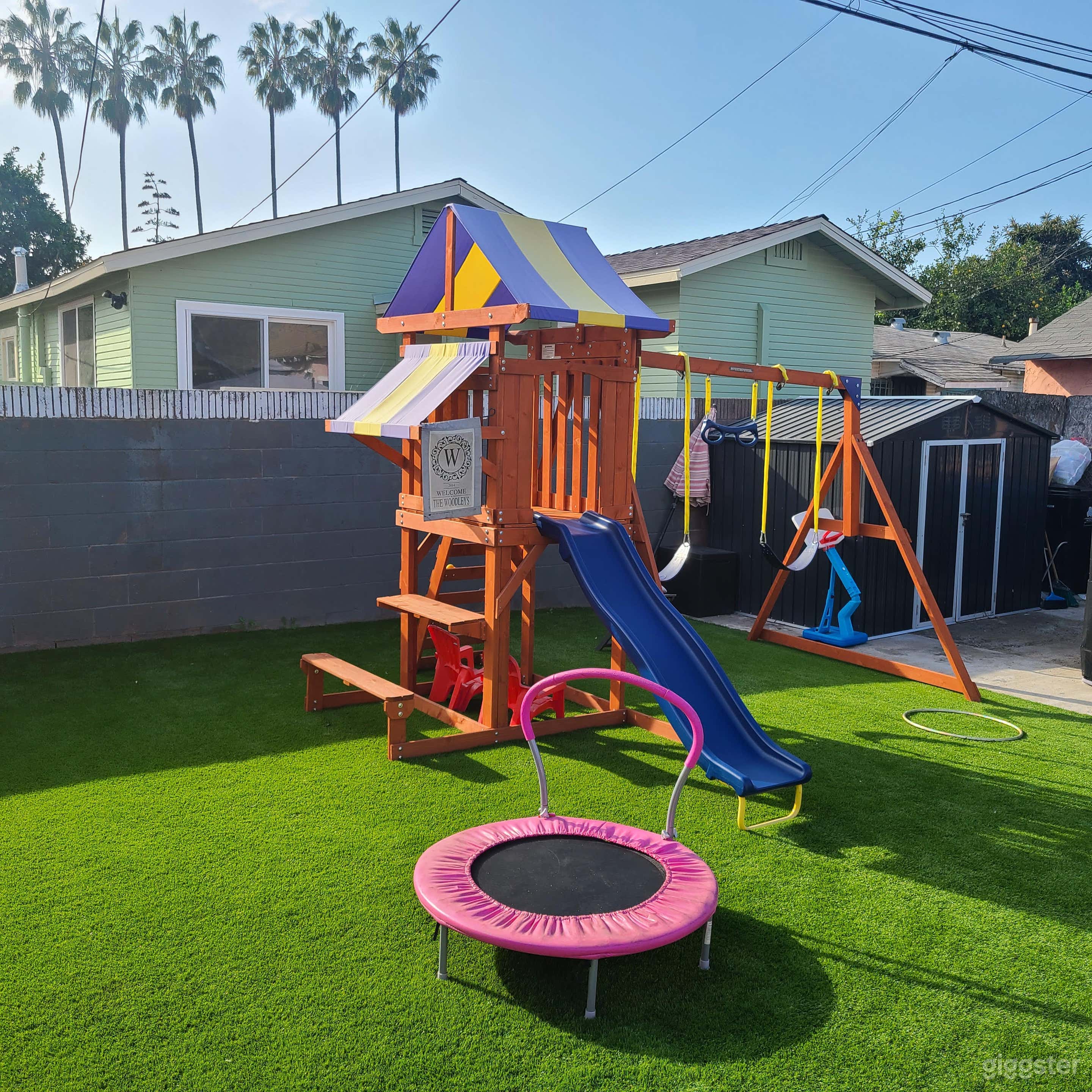 Vibrant Backyard with Playset and Patio Photo 3