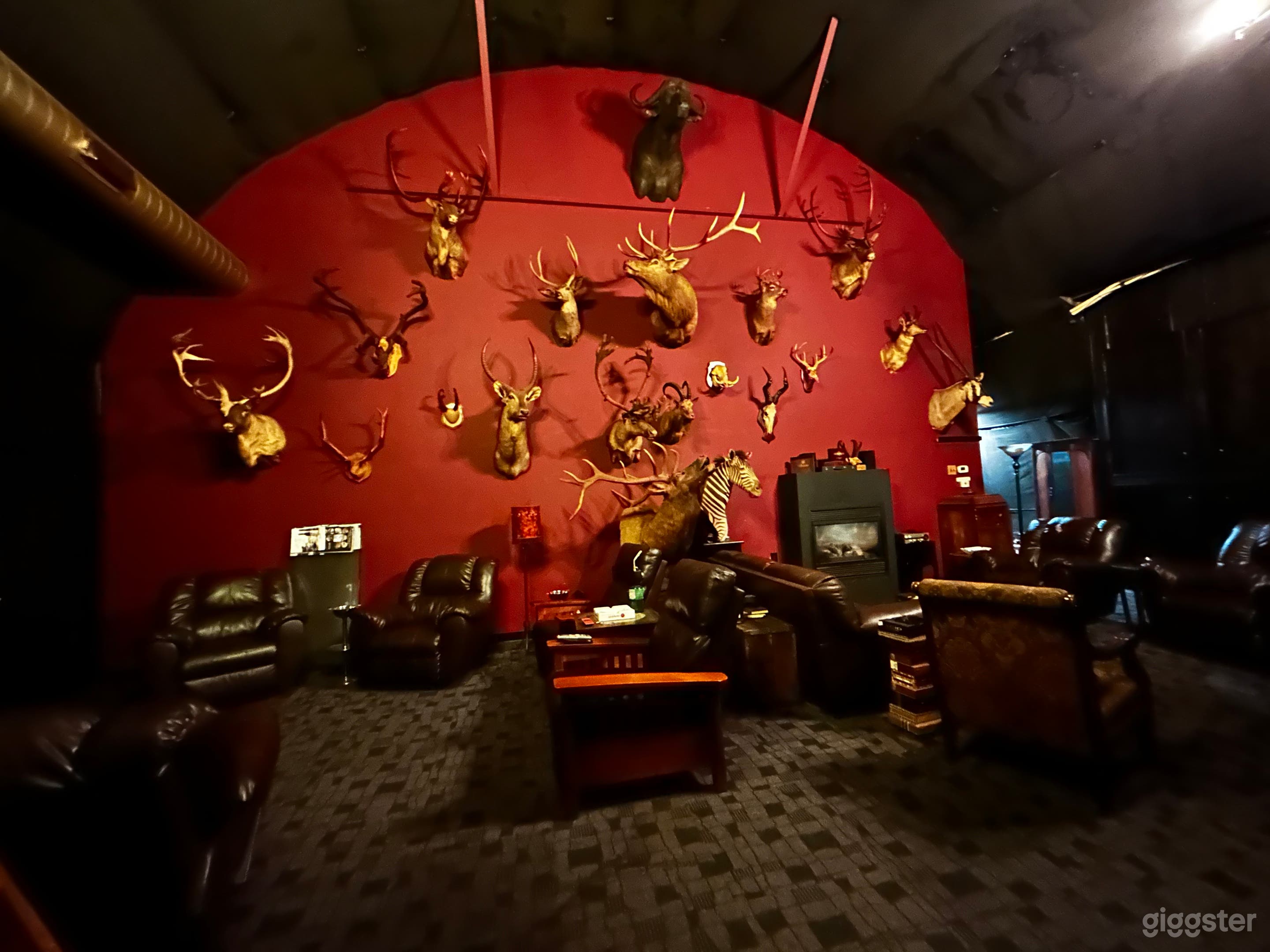 700 sq ft VIP speakeasy cigar lounge space, hunting trophy wall with fire place, sofas and easy chairs 