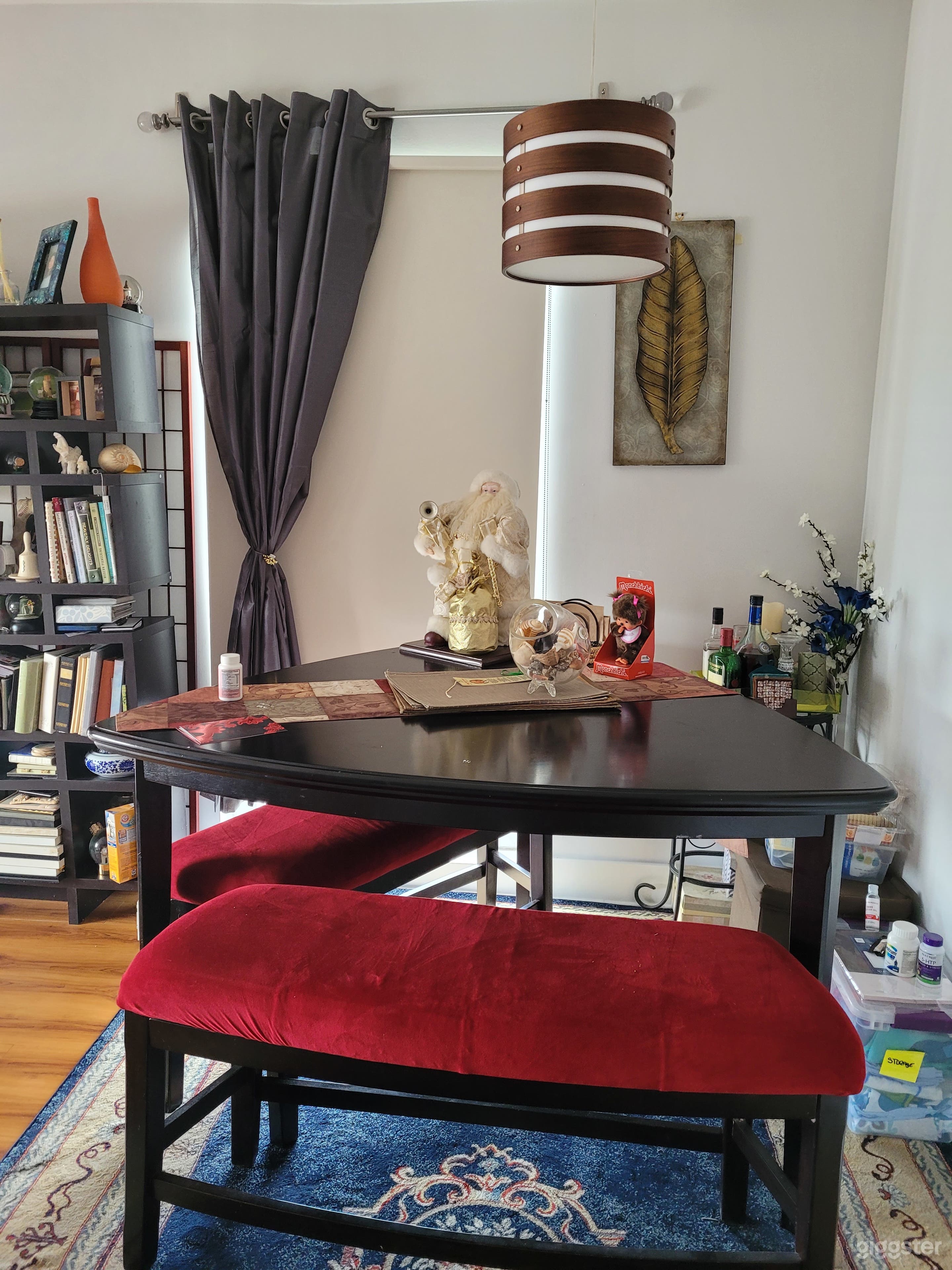 Dining room and living room with triangle table and tucked in benches.