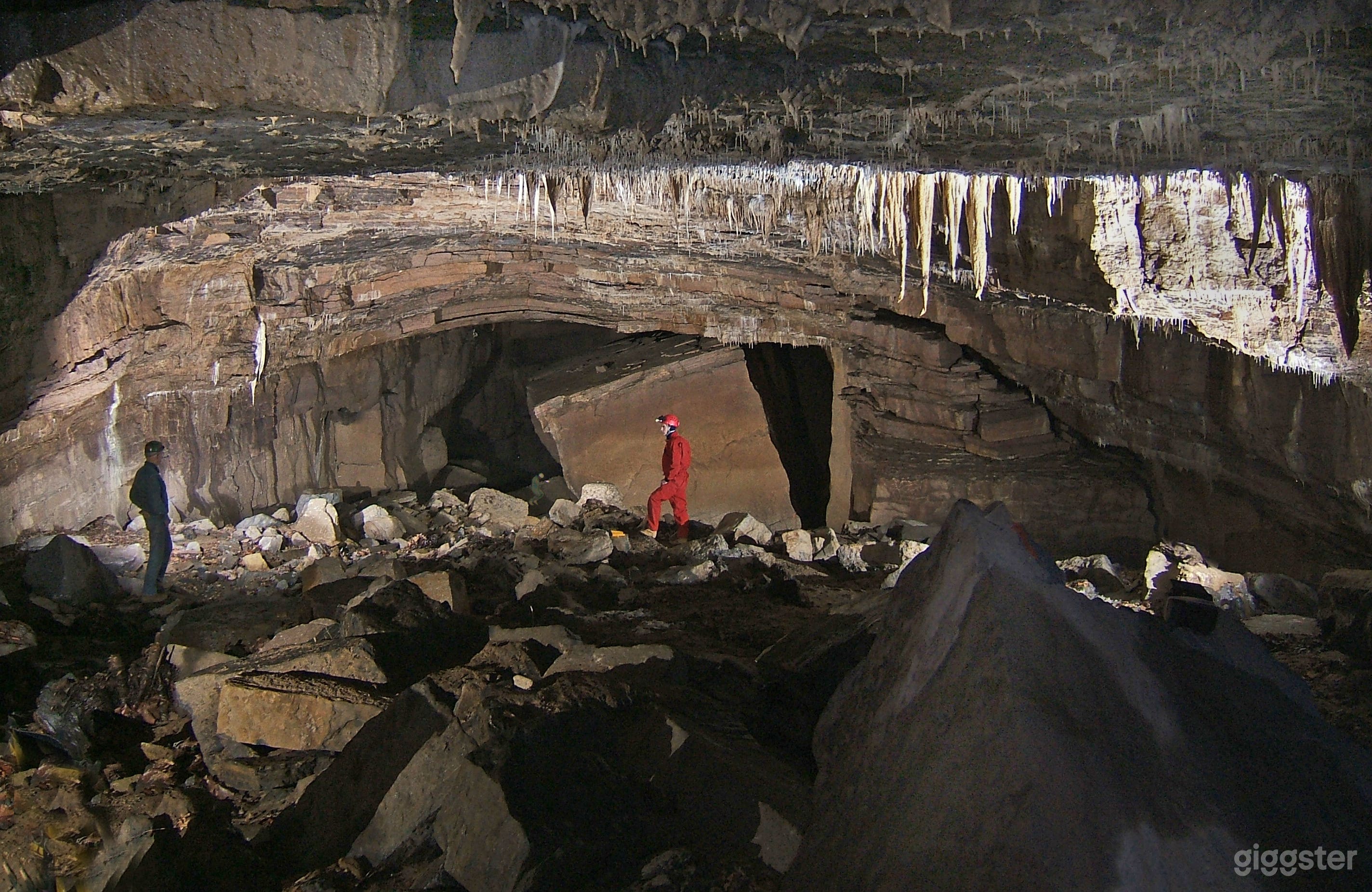 Large passages are found in the caves on this property. In this passage, called the Subway, there is a large rock. Notice the tiny image of a person beside the rock. 