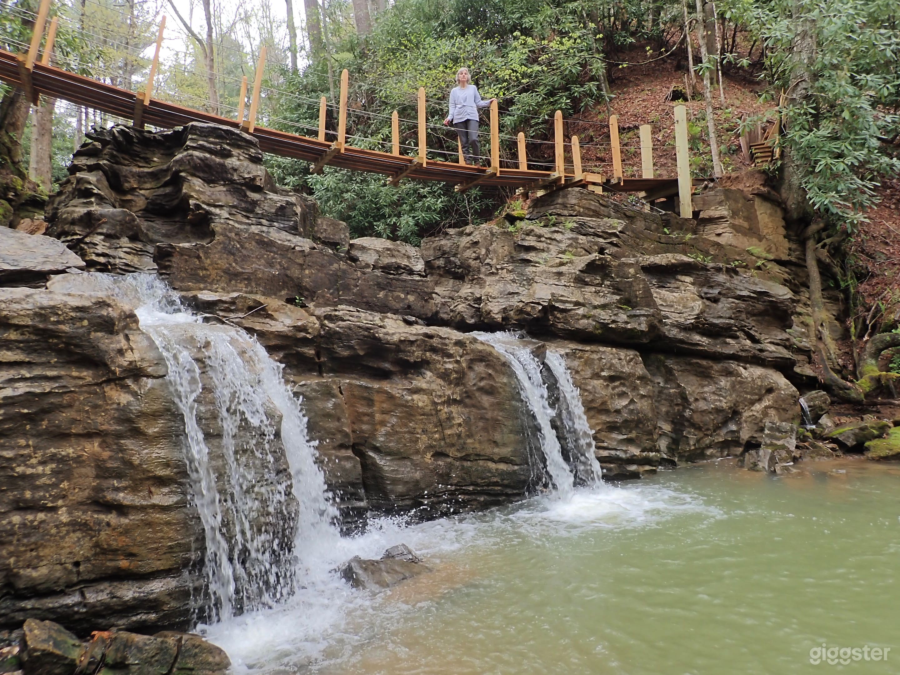 This swinging bridge crosses a waterfall ledge.