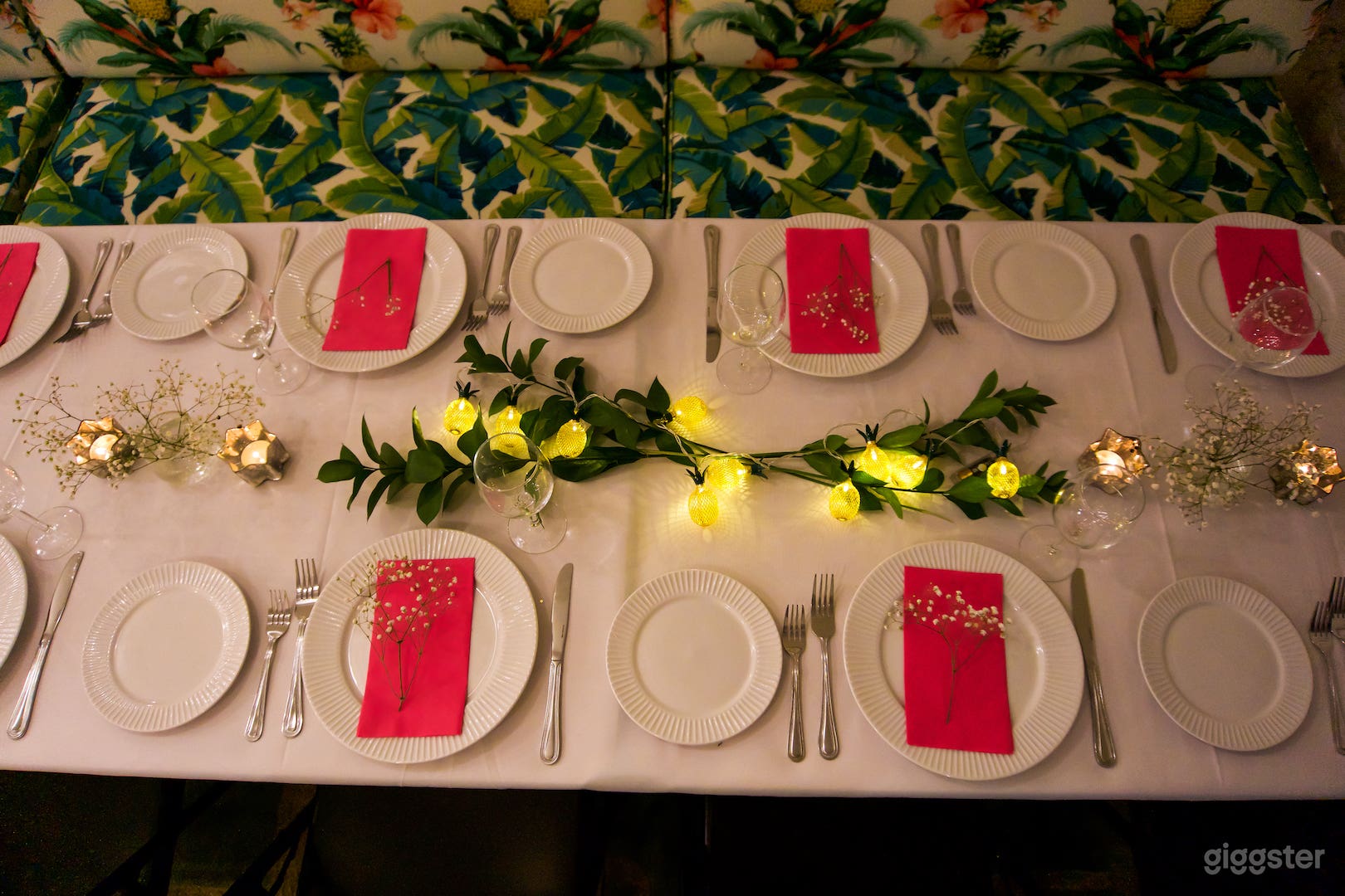 French-White dinnerware and pineapple string lights set the mood