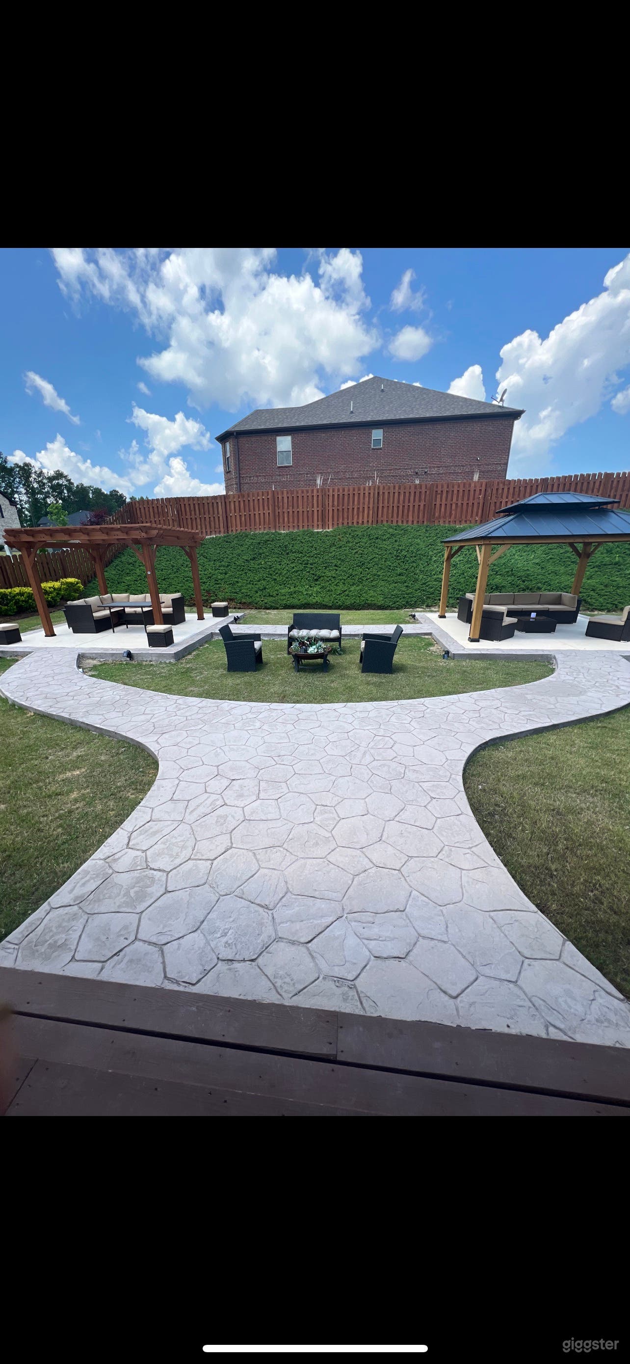 Backyard with furnished gazebo and pergola