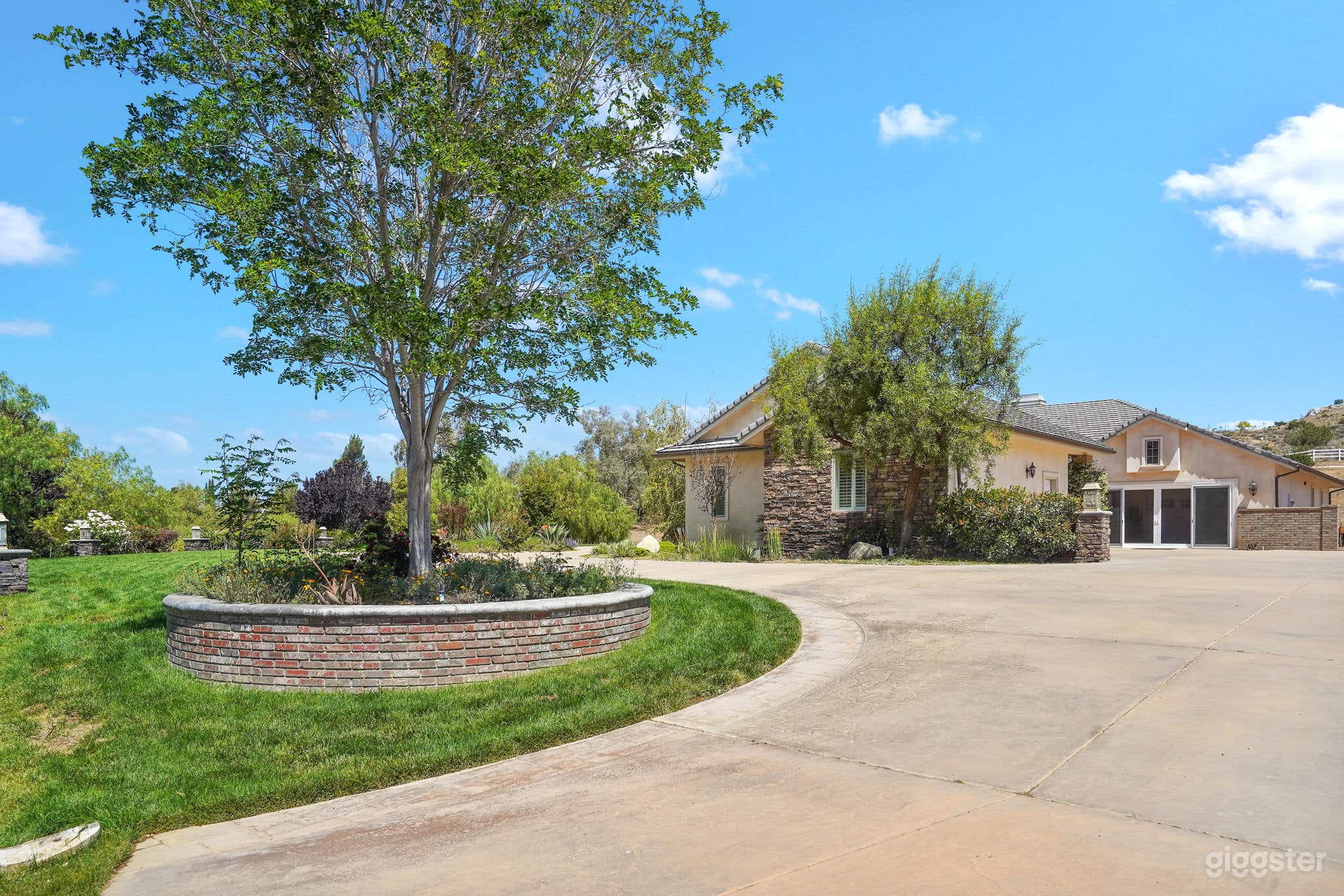 Expansive driveway with trees and lawn