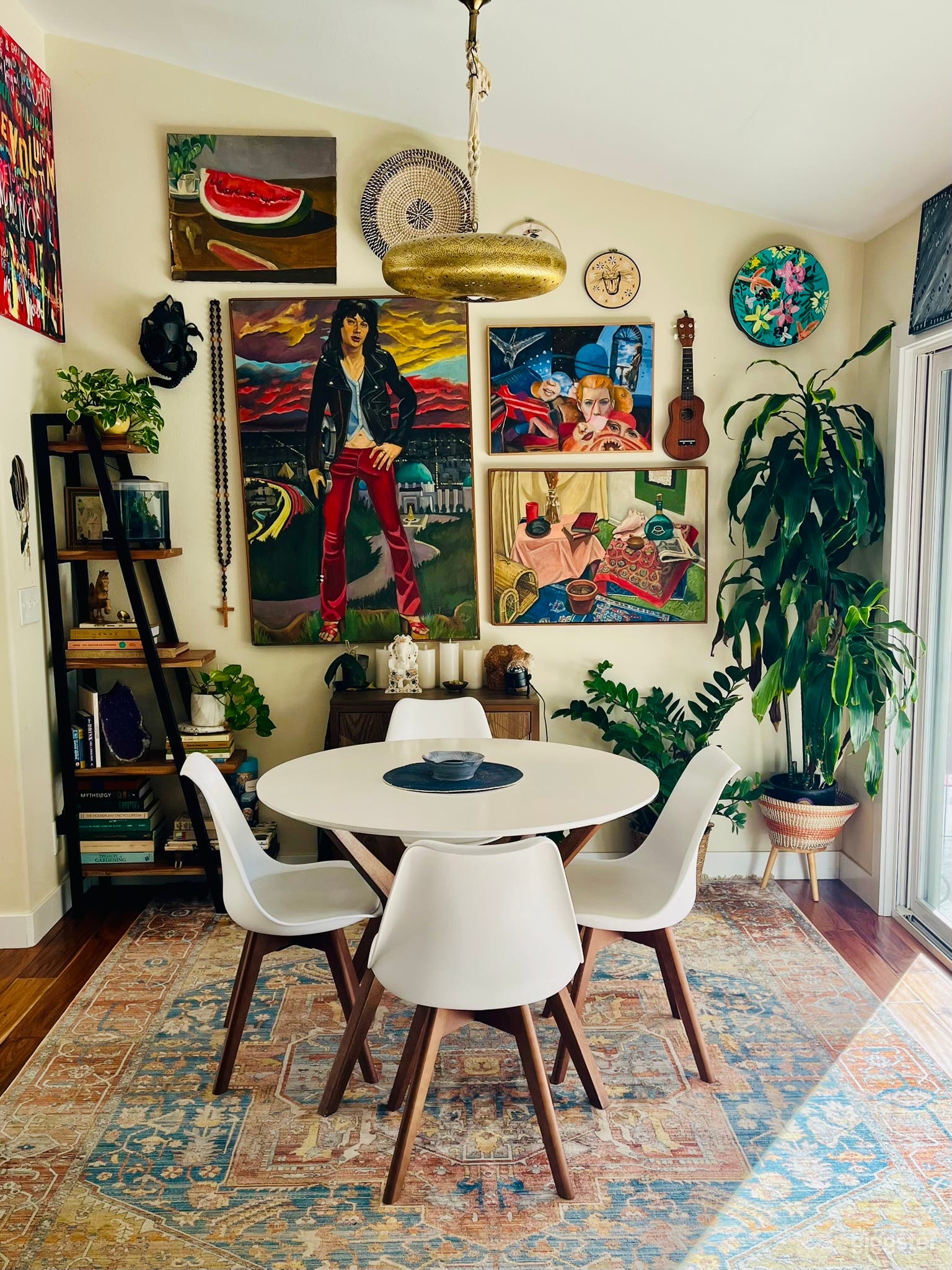 Eclectic dining area surrounded by original artwork, instruments, and lush greenery. Ideal for lifestyle or interview shoots, creative conversations, and scenes that call for artistic depth and personality.