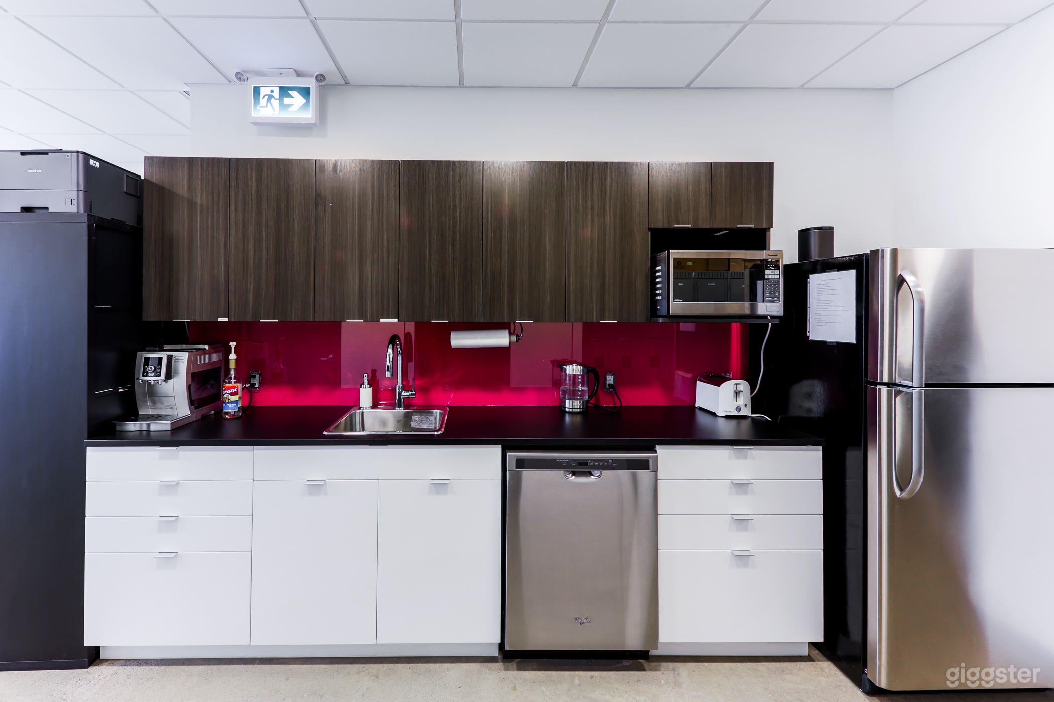 Staff lounge with a fridge, dishwasher, sink, cutlery and dishware, microwave, coffee machine, dining table, and couch