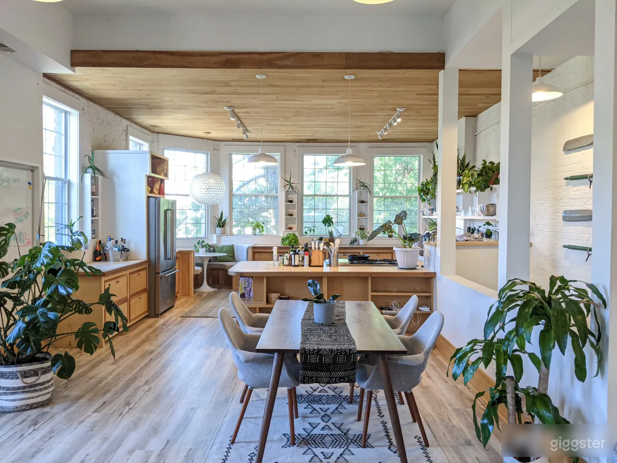 Kitchen/Dining area with bright, natural lighting and lush greenery