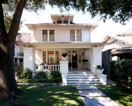  Front facade with large porch with seating. 