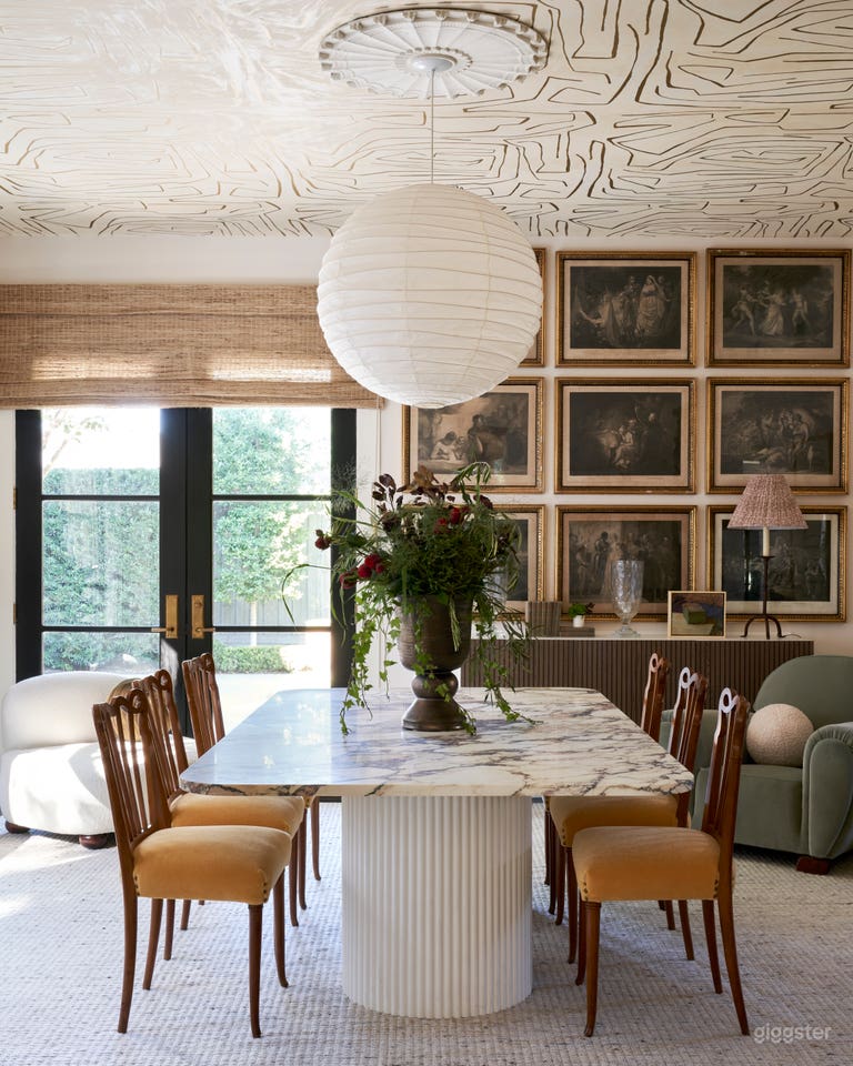  View of the dining room/ conference room from the living room. French doors lead to the formal backyard. 