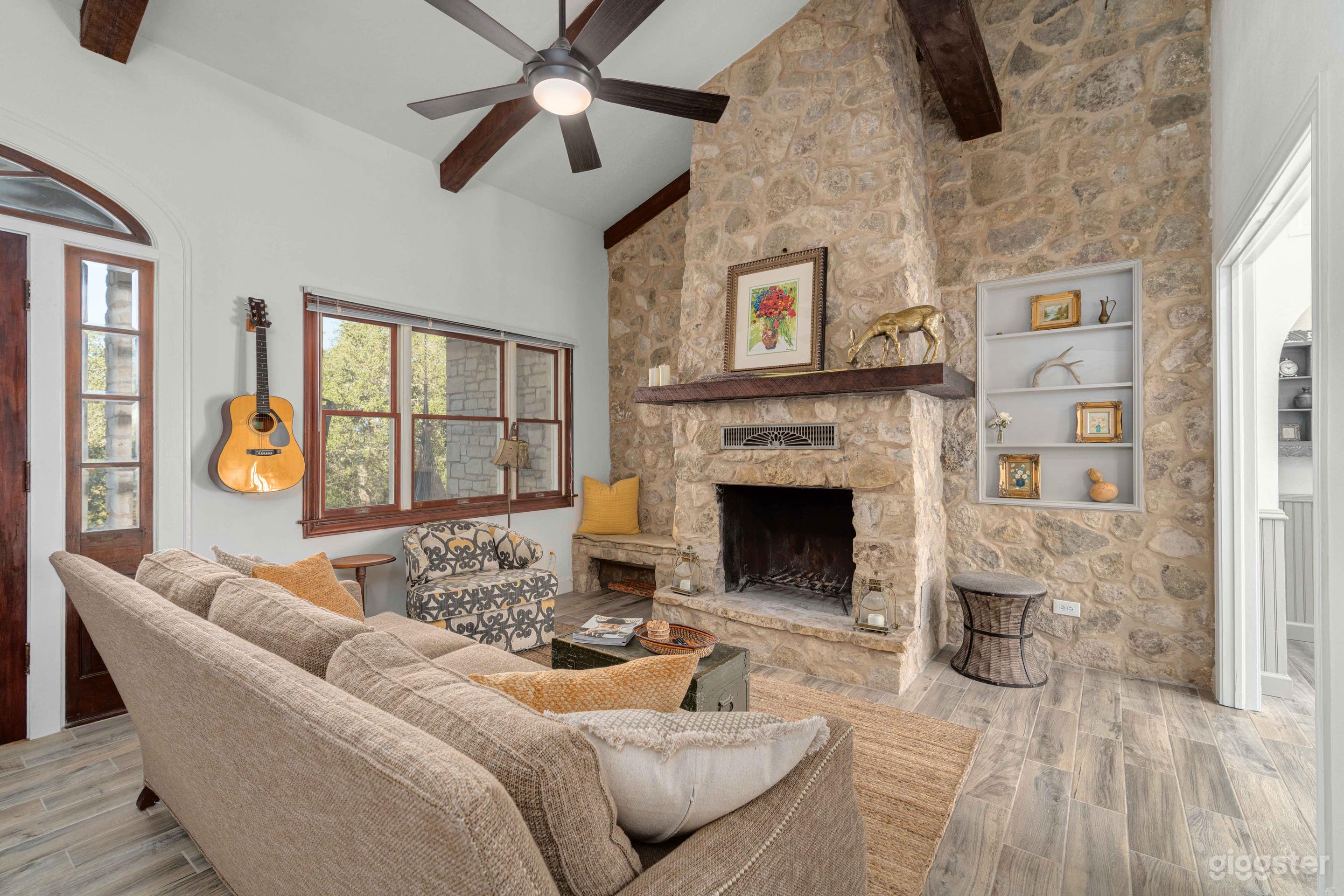 Great room with wood fireplace, 13 ft ceilings, and exposed wood beams