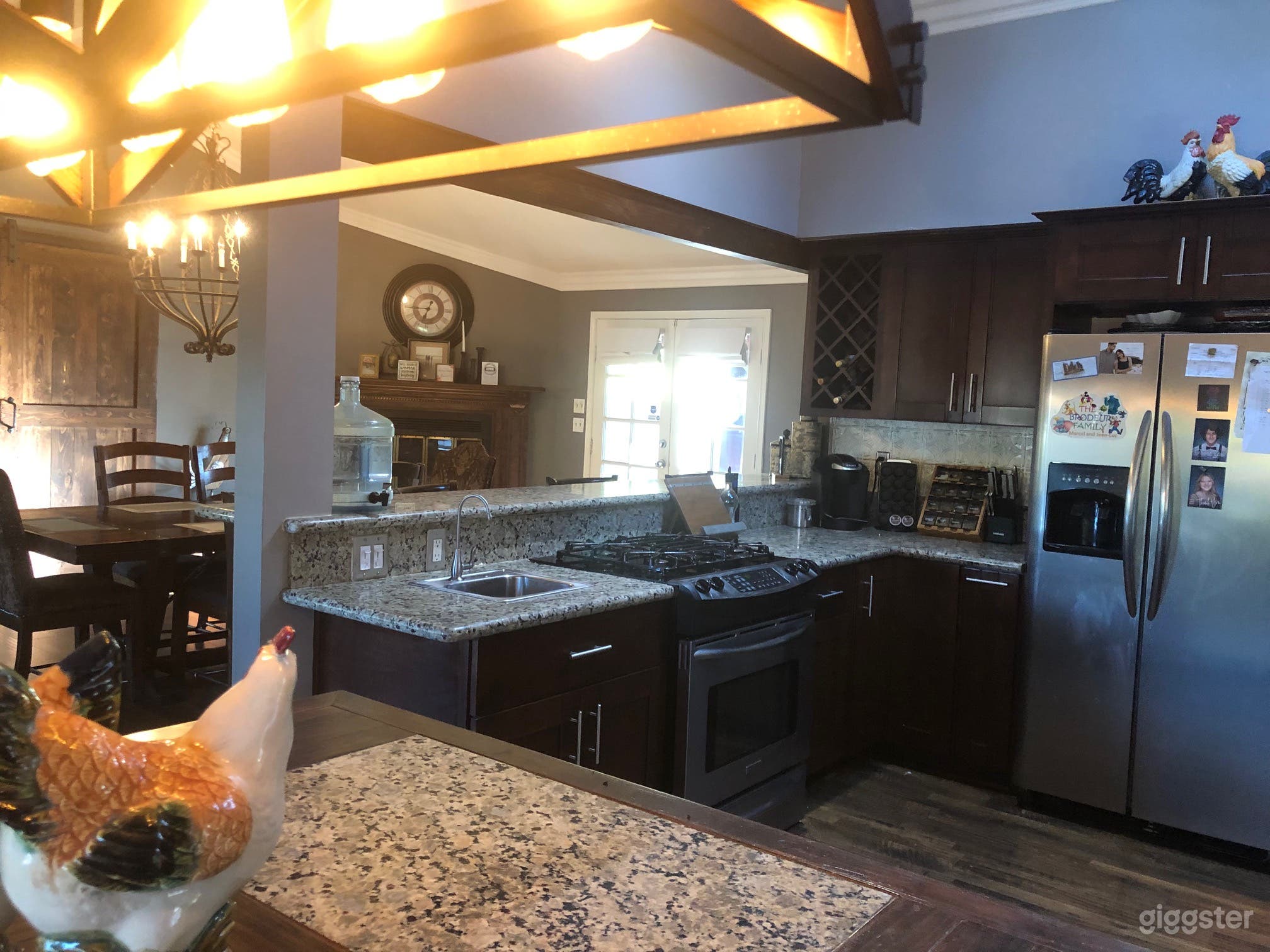 Kitchen and dinning room with French doors that open onto the deck with roman shades