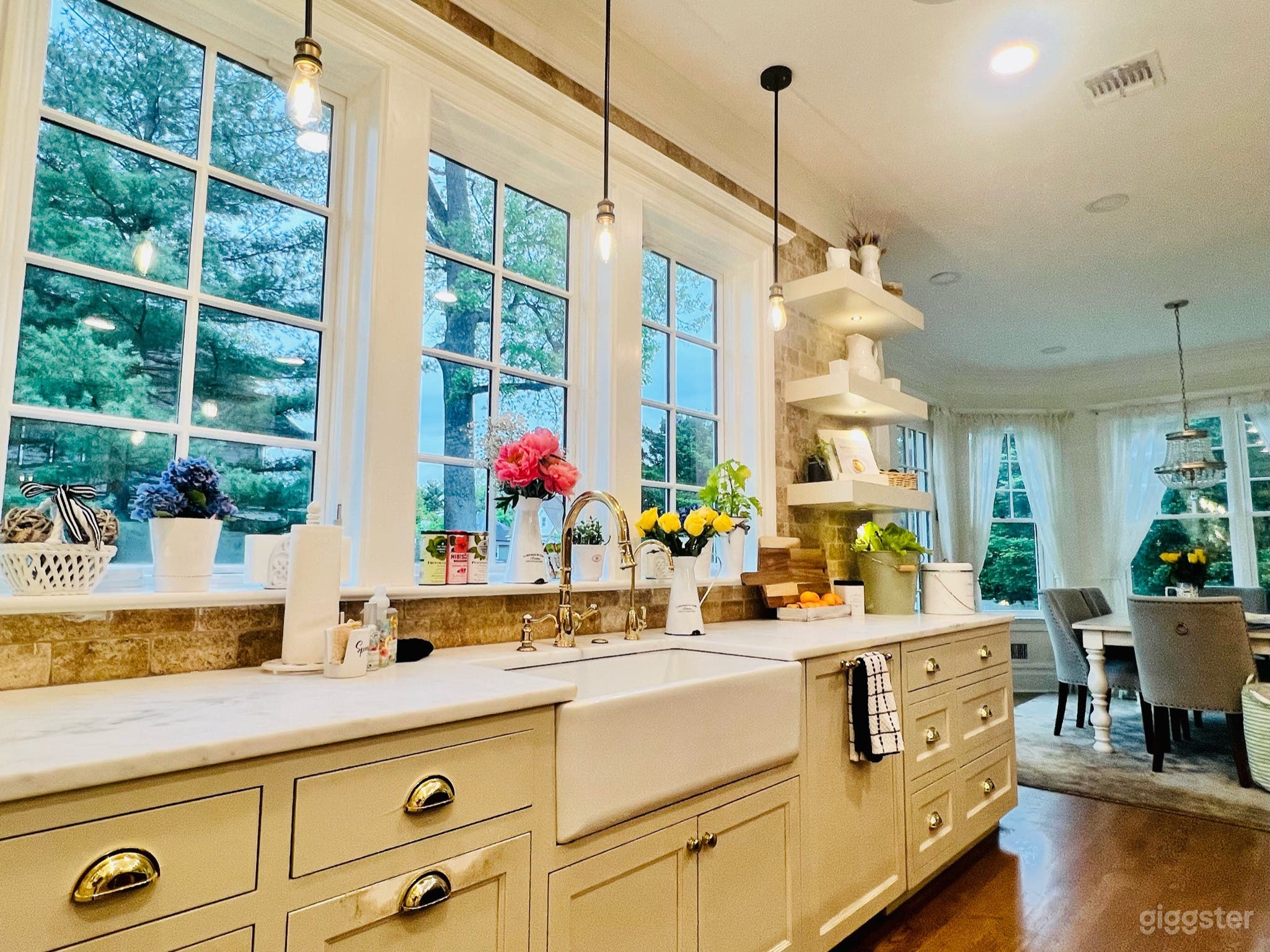 Stunning open concept chef's kitchen with large center island, farmhouse sink and tons of natural light