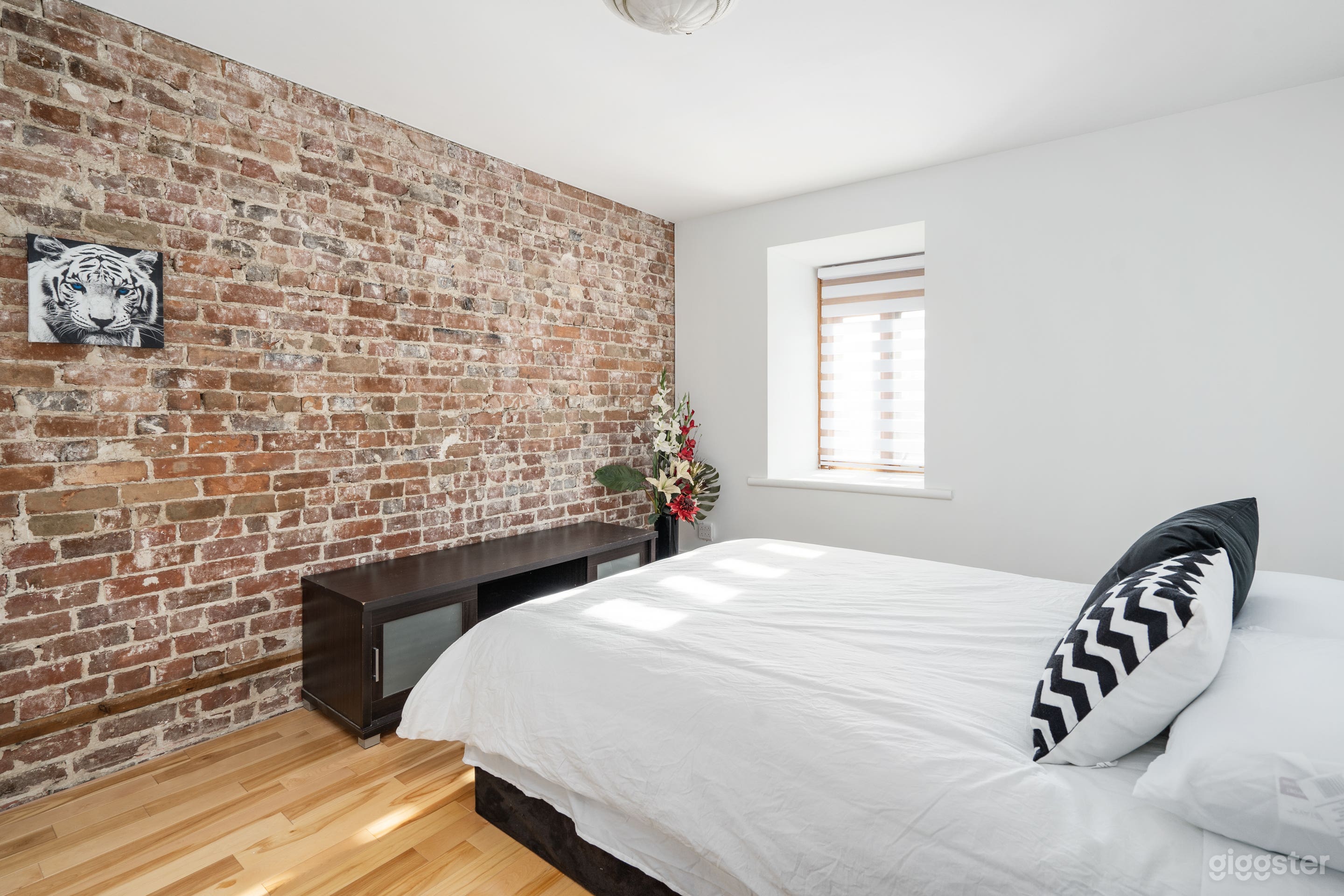 One of the six beautiful bedrooms with views of the Lachine Canal and the heritage brick wall.