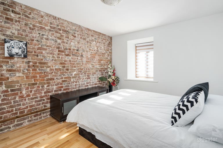  One of the six beautiful bedrooms with views of the Lachine Canal and the heritage brick wall. 