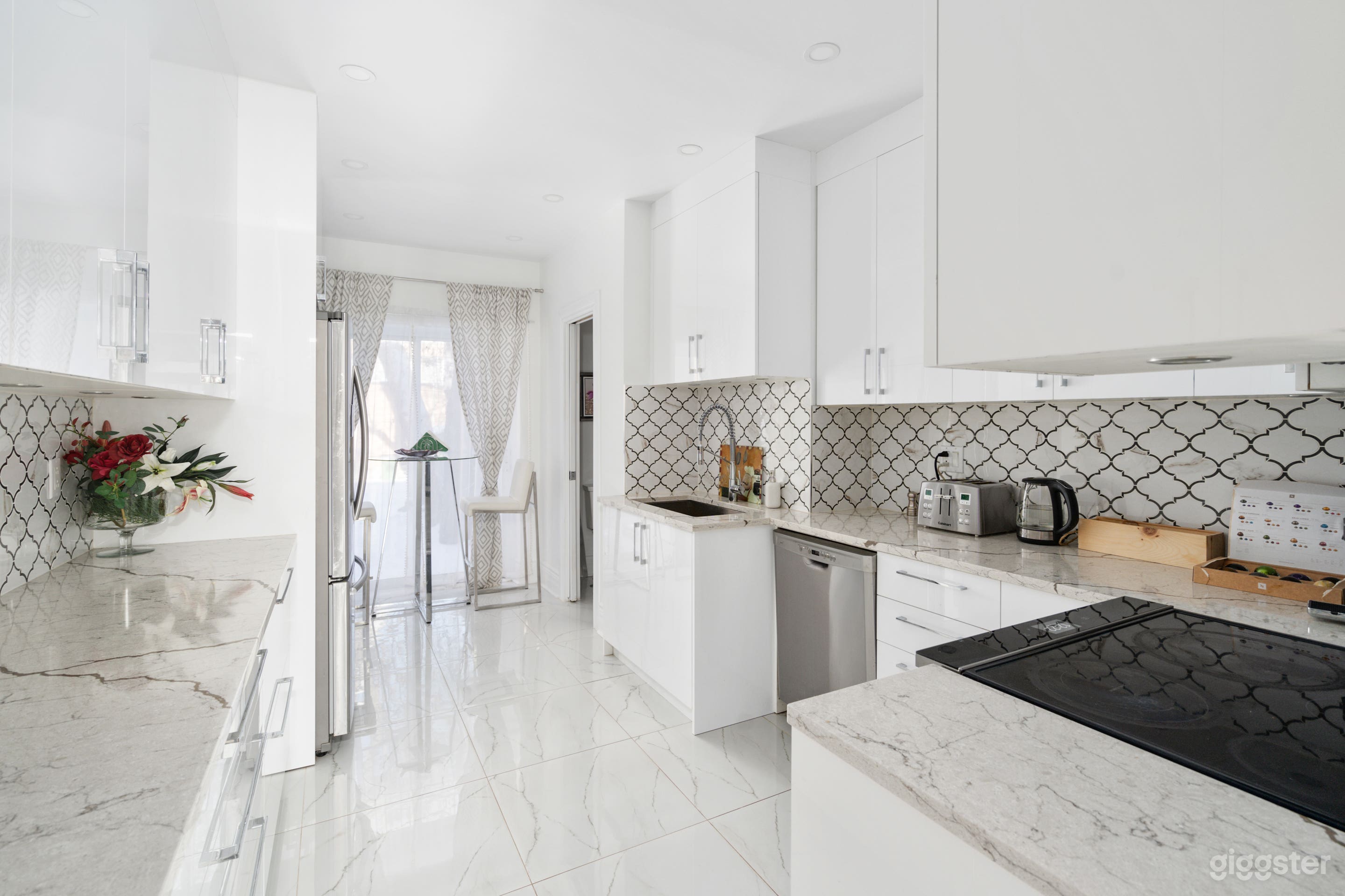 Gorgeous white glossy modern kitchen fully equipped with an exit onto the rear balcony.