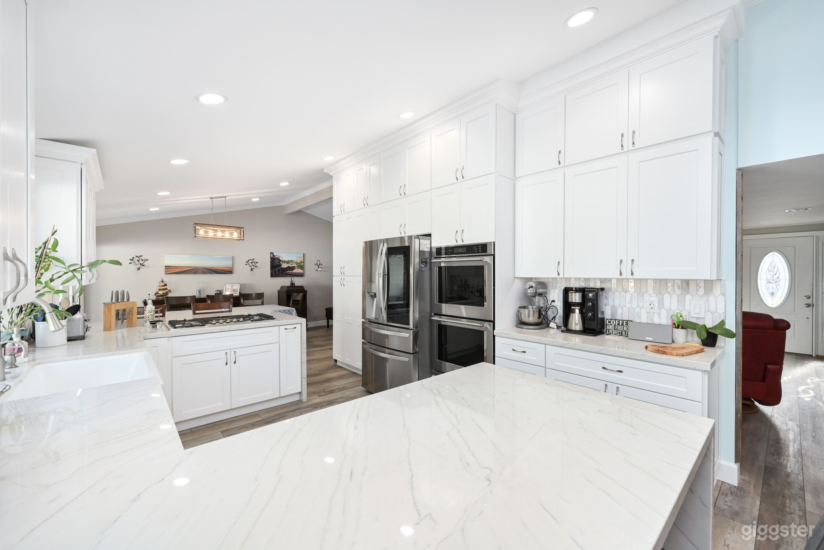 New kitchen with wall to ceiling cabinets, quartzite counters and stainless steel appliances.