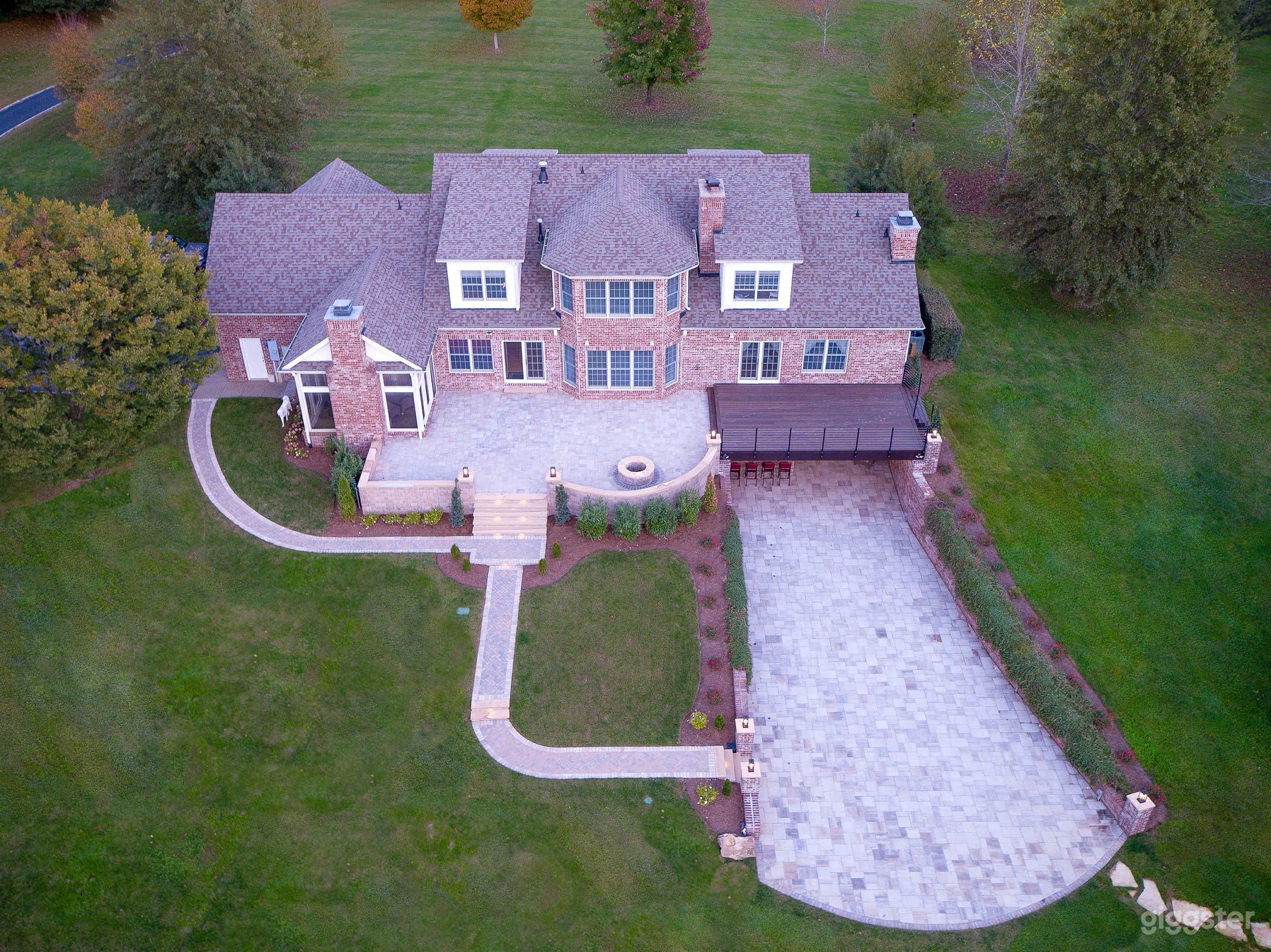 Aerial view of the back of the main house and upper and lower patios and deck.
