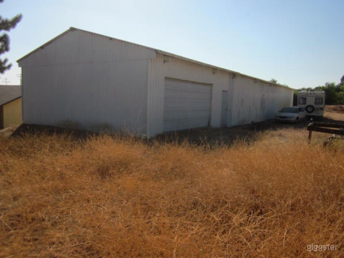 Warehouse rear left with rear overhead door &amp; rear entrance door. Note that all dry vegetation was cleared