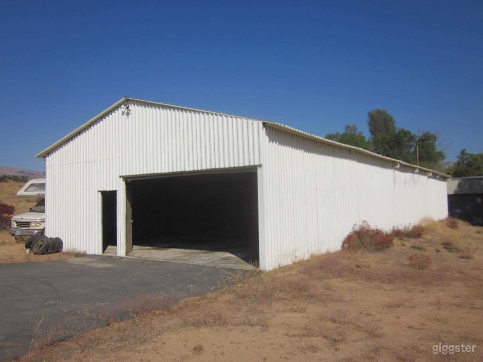 Warehouse front right.
Also has rear left side overhead door entrance and door entrance. Water and hard wired 110 &amp; 240 volts available. 