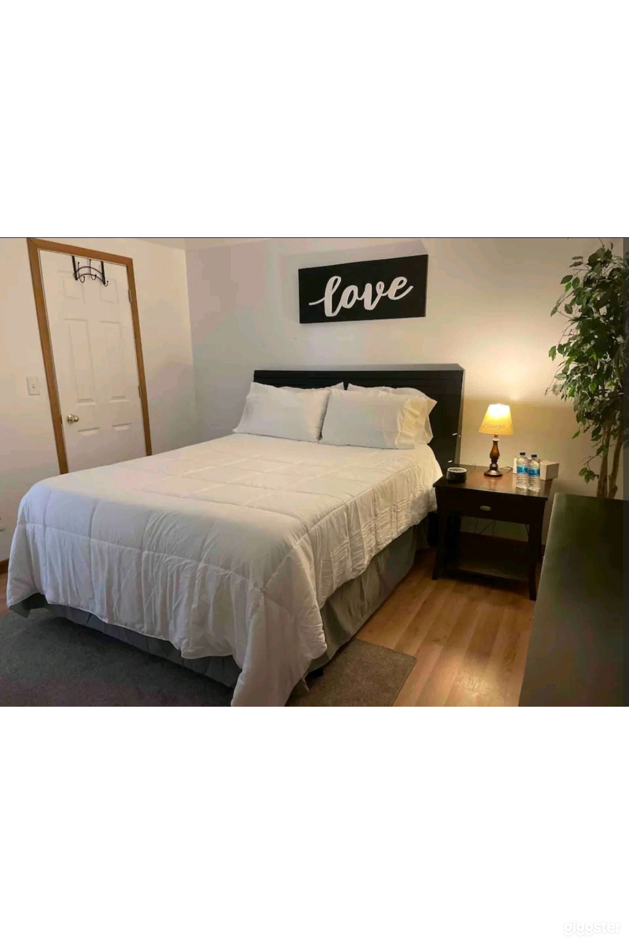 Bedroom with queen bed and light decor
