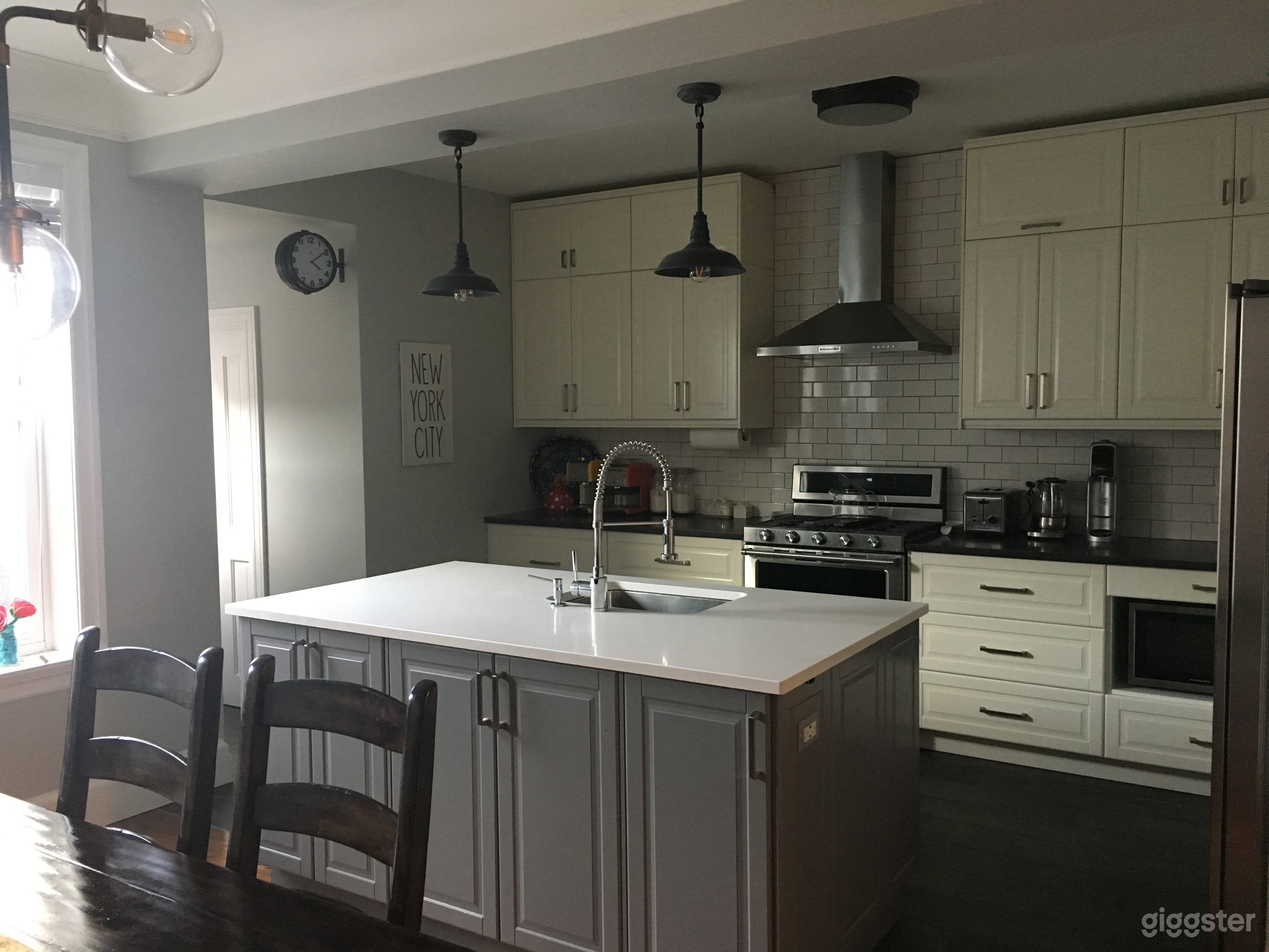 Kitchen with hallway to backdoor and city-living backyard. 