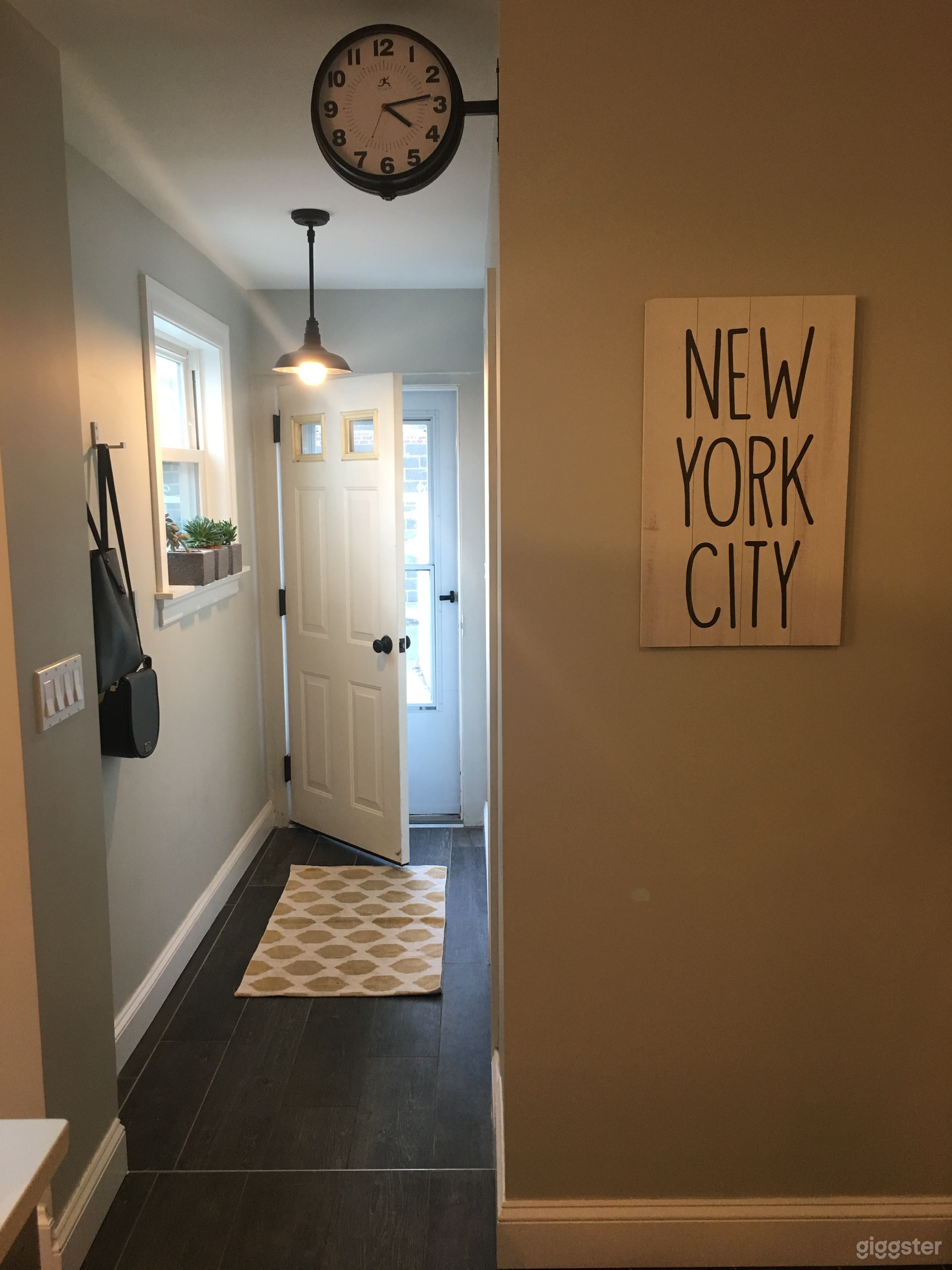 Back entrance to the house that leads into the kitchen. Main floor bathroom is off this hallway. 