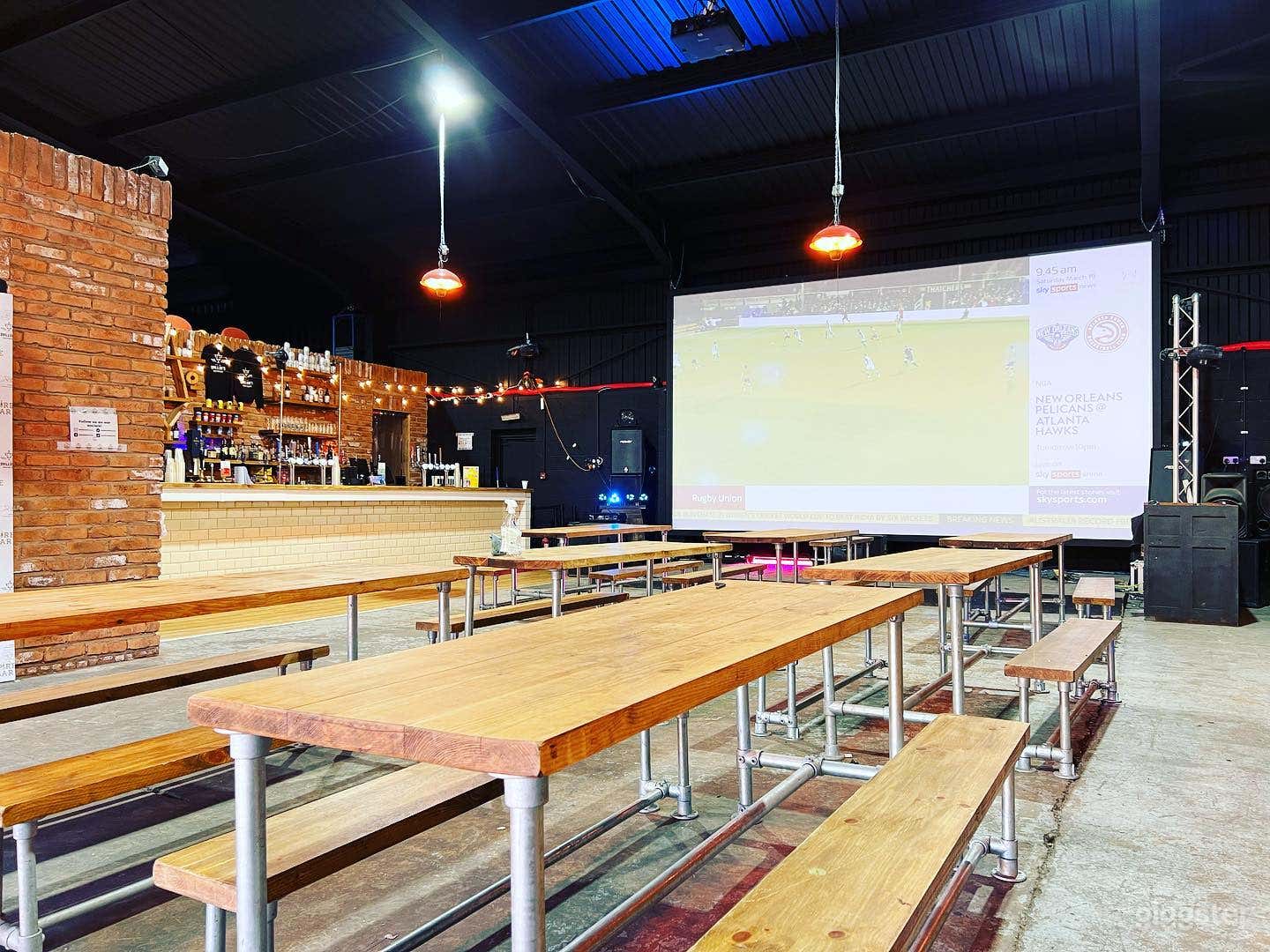 Interior facing stage, cinema screen and DJ box