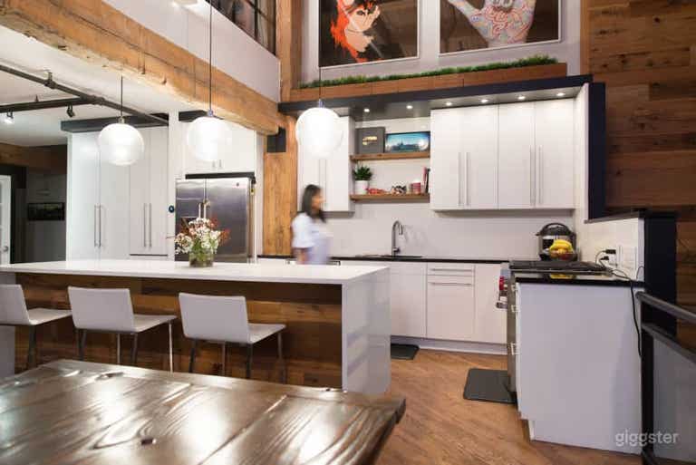  Large white kitchen with massive waterfall island 