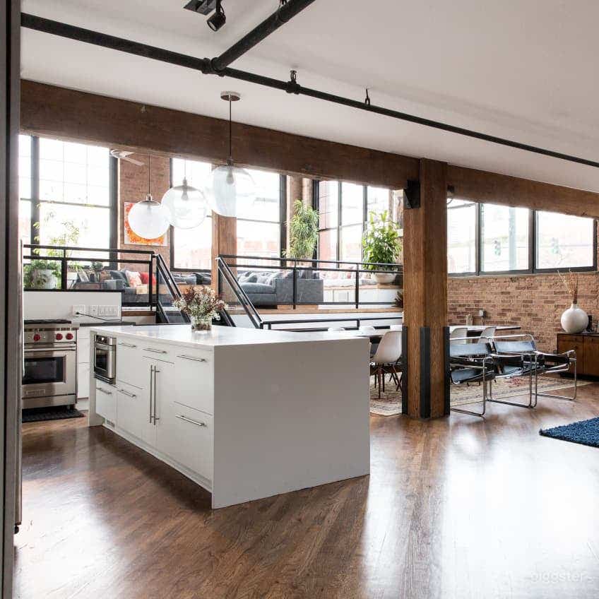 Main floor with timbers beams, high ceilings and large windows. 