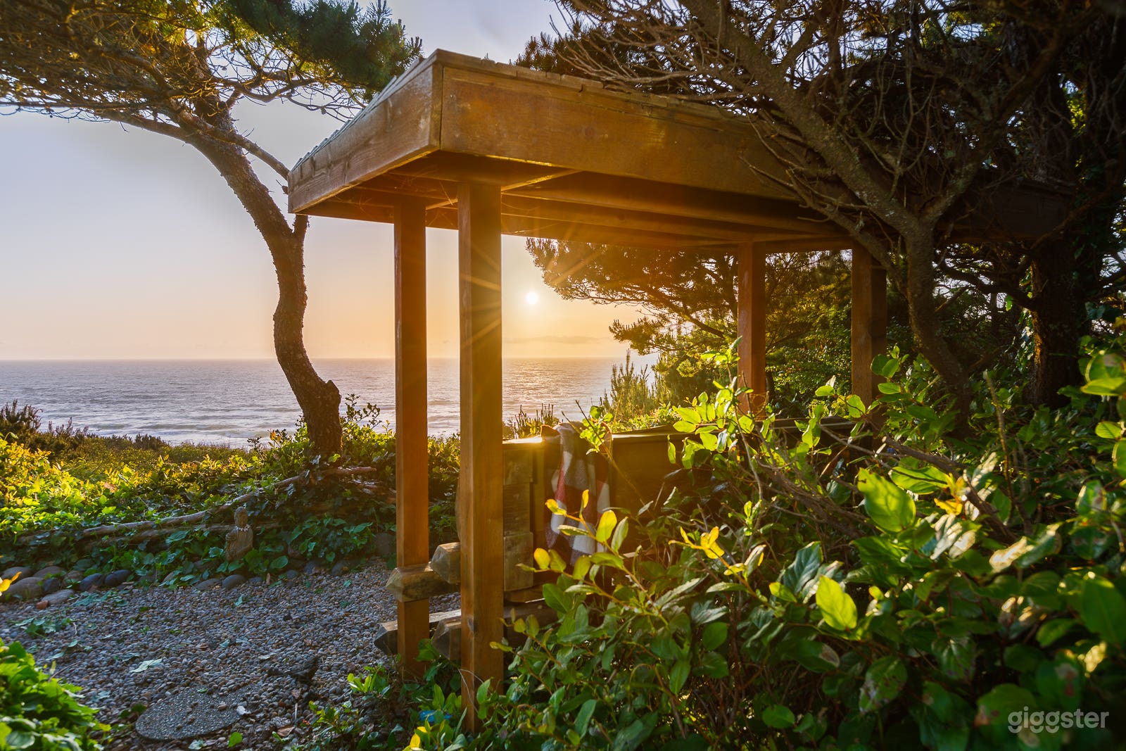 One of two benches on bluffs with view of ocean and lighthouse.