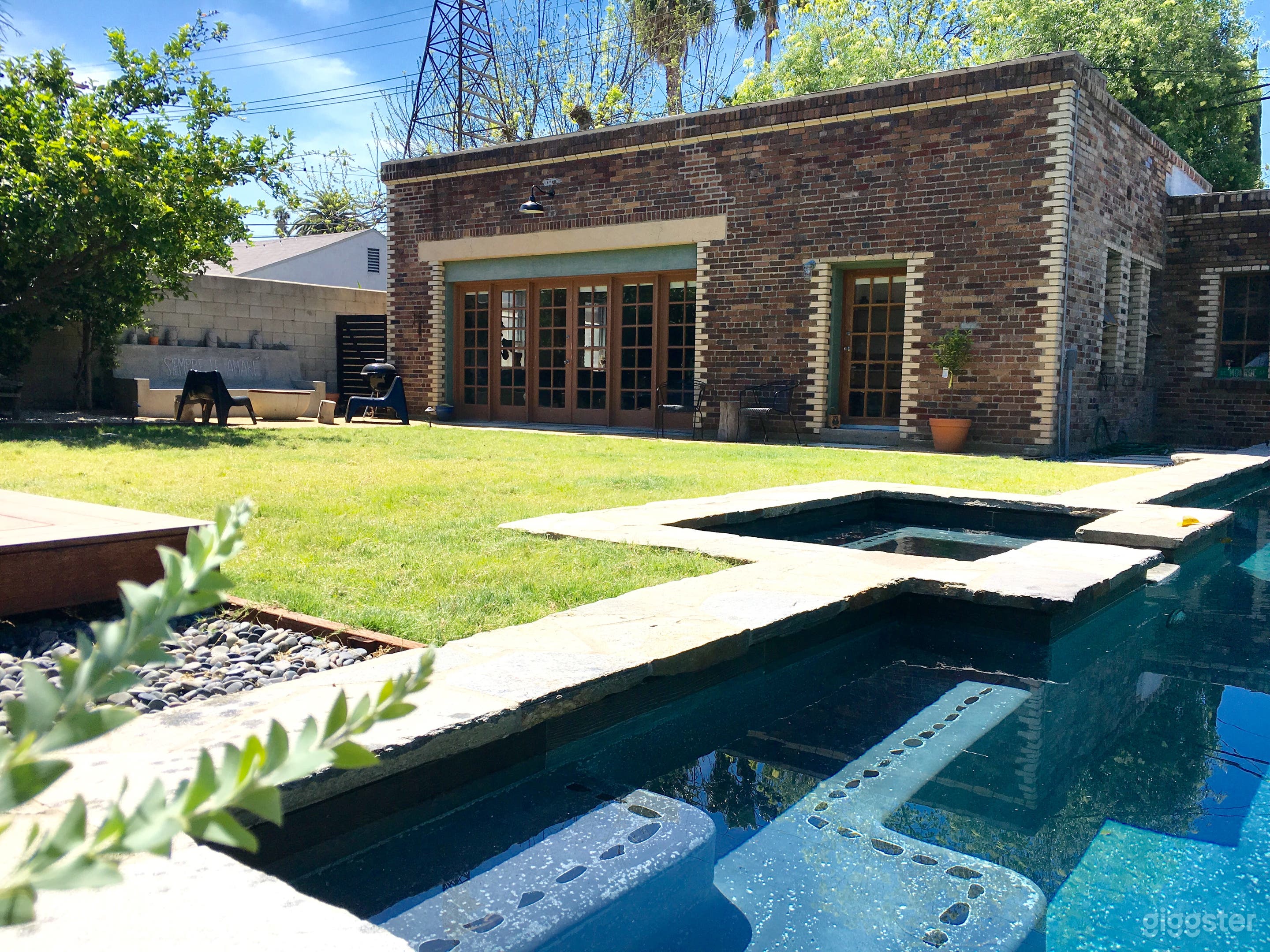 Chic loft-style Oasis featuring lush backyard with fruit trees, long lap pool and and cozy fire pit