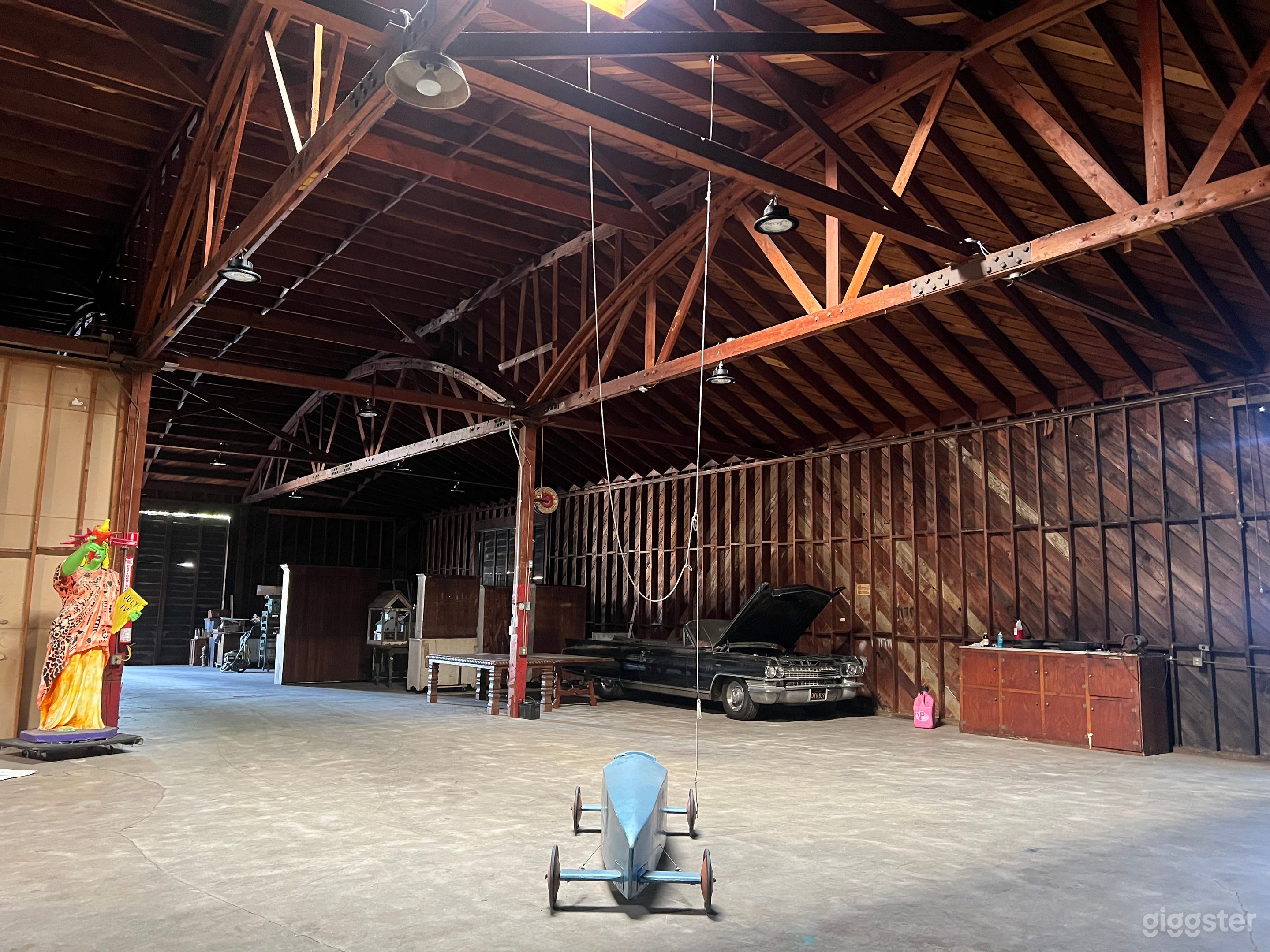 Part of the Main whse. Features high bay dimmable led lighting. 25 foot ceilings Exposed Beam and truss interior. High bay doors open so a semi truck can drive in.