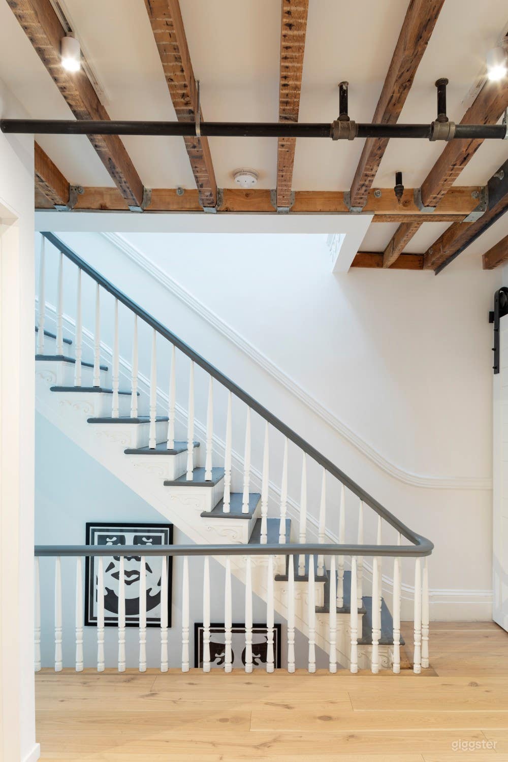 Original staircase and exposed beams in ceiling