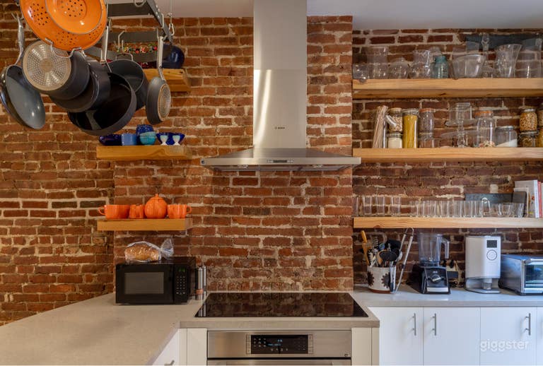  Kitchen with exposed brick, reclaimed wood shelves, natural light 